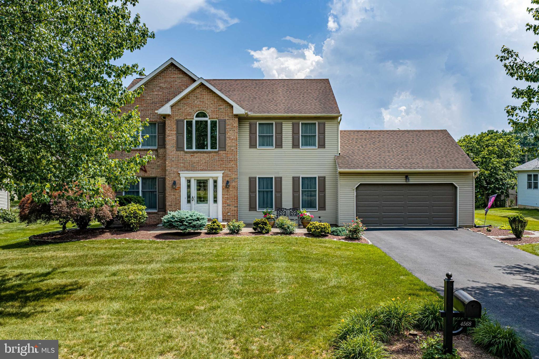 Welcome to 4568 Greenfield Road, an exceptional Colonial nestled in the highly sought-after Pointe North neighborhood of Hanover Township. Offering over 2,266 square feet of beautifully maintained living space, this 4-bedroom, 2.5-bath home combines timeless craftsmanship with thoughtful updates, making it the perfect place for your family to grow. From the moment you arrive, you'll appreciate the home's outstanding curb appeal, highlighted by mature landscaping, a stately brick facade, and an inviting grand foyer that sets the tone for everything inside. Rich, original hardwood floors flow throughout the home, creating warmth and character rarely found today. Designed for both everyday living and entertaining, the spacious eat-in kitchen features updated finishes, abundant cabinetry, a center island, and seamless access to the open family room where a stunning wood-burning brick fireplace creates the perfect gathering space. A formal dining room provides an elegant setting for holidays and special occasions, while the generous living room offers additional flexibility for entertaining or a home office. Upstairs, the spacious primary suite offers a peaceful retreat with a beautifully updated ensuite bath. Three additional oversized bedrooms, generous closet space throughout, and an updated full bath provide room for everyone. The unfinished basement offers endless possibilities to create a home theater, fitness room, recreation space, or additional living area while providing exceptional storage. Step outside to your private backyard oasis featuring a beautifully landscaped 0.279-acre lot, attractive paver patio, lush gardens, and plenty of room for children, pets, and outdoor entertaining. Located within the highly regarded Bethlehem Area School District, this home is just minutes from Hanover Township Community Center, local parks, shopping, restaurants, major commuter routes, and everyday conveniences, offering the perfect balance of peaceful suburban living with easy access to everything the Lehigh Valley has to offer. Hanover Township's Community Center and Municipal Park feature walking trails, sports fields, playgrounds, tennis courts, a dog park, and recreational programming, making the neighborhood especially attractive for active families. This is a rare opportunity to own a meticulously maintained home in one of Hanover Township's most desirable neighborhoods.