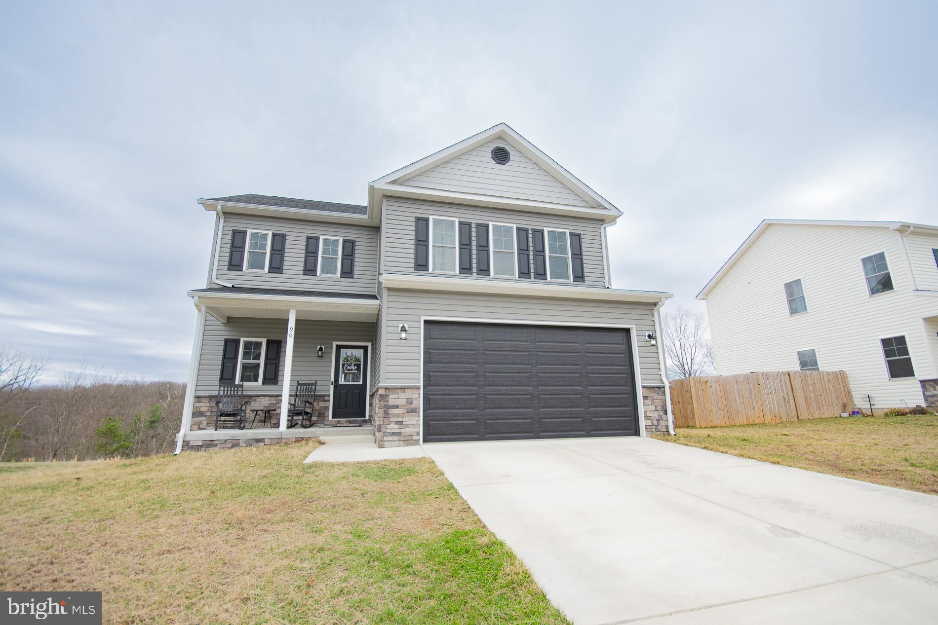 This beautiful home welcomes you with a charming front porch—perfect for displaying seasonal décor. Inside, you’ll find 9-foot ceilings and luxury vinyl plank flooring throughout the main level, along with a convenient half bath and a spacious open-concept living area featuring an electric fireplace.

The kitchen truly shines with soft-close cabinets, black stainless steel Samsung appliances, upgraded quartz countertops with backsplash, and a large 10-foot island that comfortably seats up to 10 with included barstools. There’s also a generous pantry with a sliding barn door. Just off the kitchen, enjoy peaceful outdoor moments on the 12x10 back deck.

Upstairs, the spacious primary suite includes two sliding barn doors, along with two additional bedrooms, a laundry room with its own sliding barn door, and a versatile family room/loft—perfect for relaxing or customizing to your needs. This cozy space also features an electric fireplace, a large couch, and two ottomans.

The walk-out basement includes a full bathroom, and the home is completed with a two-car garage.

This is truly a MUST-SEE home!