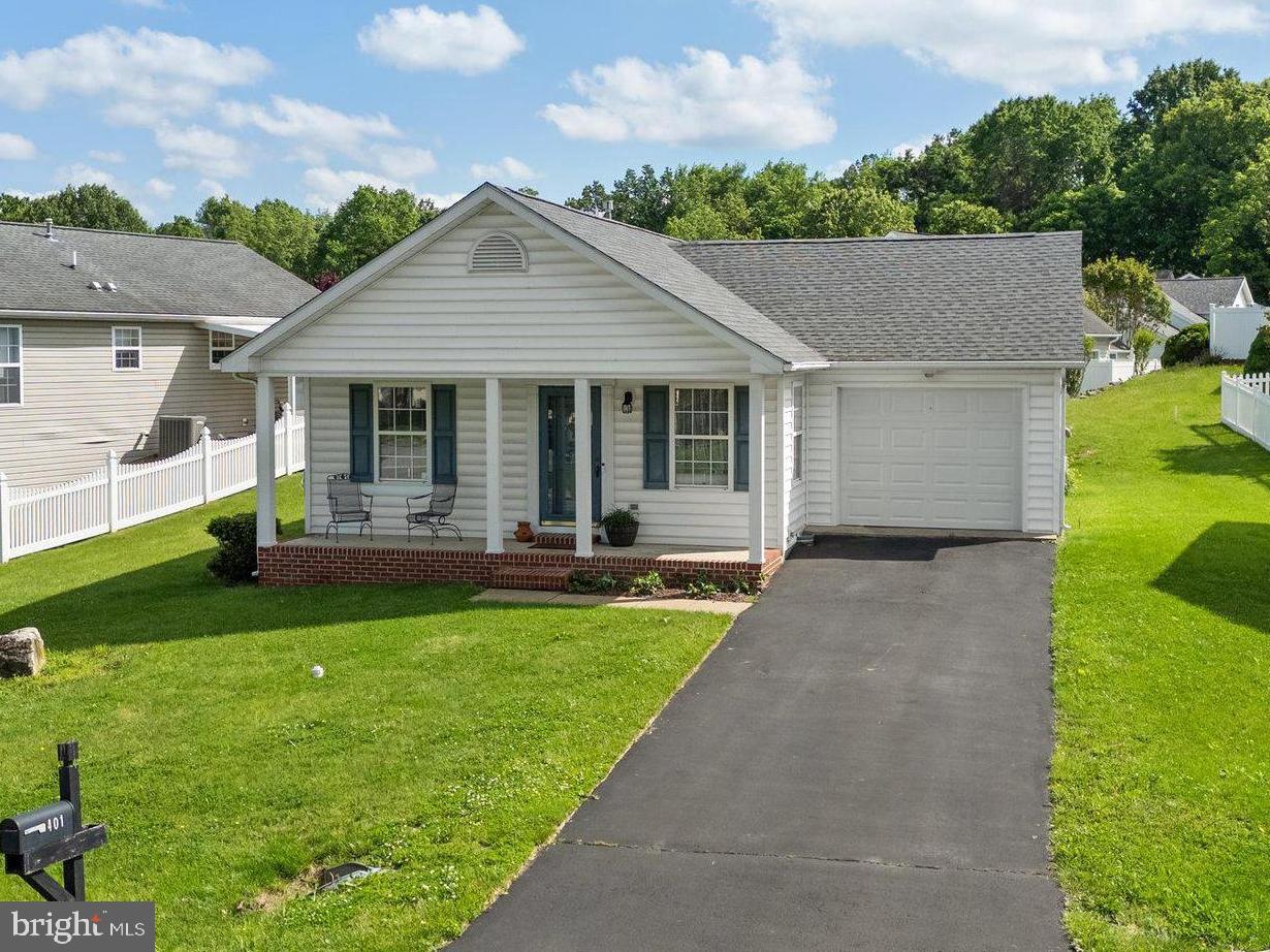 Well-maintained and thoughtfully designed, this 2 bedroom, 1 bath home offers easy one-level living, a cute front porch, and inviting outdoor space.
Step inside to find wood floors in the main living areas and a functional layout. The primary bedroom located towards the back of the home includes two closets and direct access to the full hall bath. The kitchen features gas cooking, a breakfast bar, and ample cabinet space. A sliding glass door in the dining area leads to a 10 x 10 concrete patio, fully enclosed with vinyl privacy fencing—perfect for relaxing or entertaining. Enjoy morning coffee or evening chats on the charming front porch. Additional highlights include a 1-car attached garage, a 50-year architectural shingle roof installed in 2023, and a natural gas furnace for energy efficiency. Located in a community with a 1-mile walking path along scenic Dry Run, plus a playground and basketball court. Conveniently close to shopping, dining, and everyday essentials.