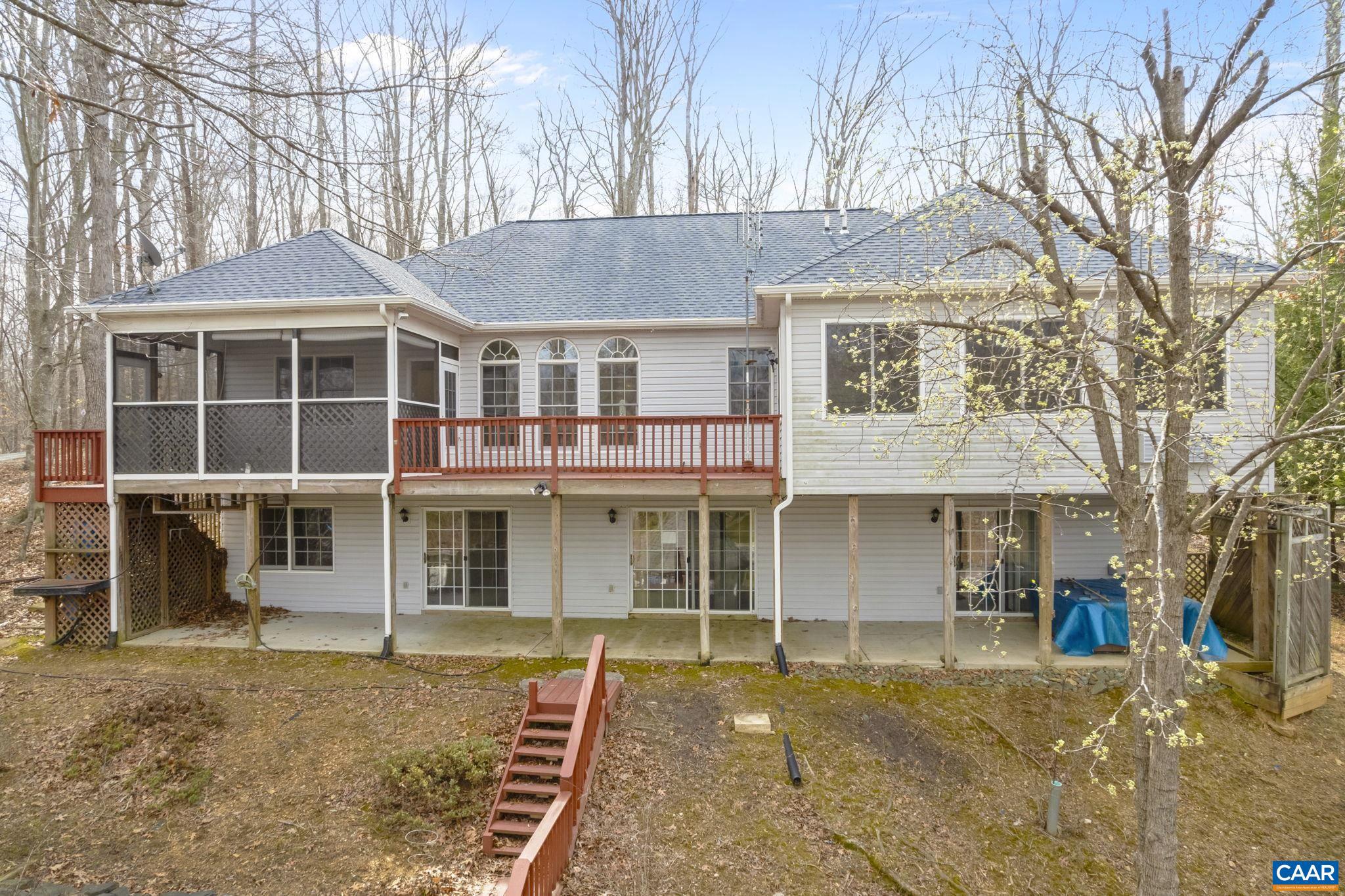 WATERFRONT ON LAKE MONTICELLO. Overlooking Jackson Cove with views to beach 4 and the main lake, this  CUSTOM built waterfront home is sure to please. Privately located on a peninsula and offering DEEP water, privacy, yet convenient to shopping. All one level living, the main floor offers open style living with exceptional views. Upon entering, you are greeted with a formal living room with gas fireplace, cathedral ceilings, large windows and views of Jackson cove. The large eat-in kitchen offers tons of counter space, loads of cabinetry gas stove with electric oven and easy access to the screened in porch. There is also easy access to the formal dining room. A large primary bedroom with tray ceilings, spa like en-suite and morning room or office are also located on the main level along with a second spacious bedroom and full bath. Terrace level includes a large family room with coal stove designed to heat the whole house, 1 more bedroom a full bath as well as tons of storage, and the possibility of a 4th bedroom. An OVERSIZED garage, custom built gazebo and bilevel dock with sitting area and boat mooring complete this exceptional offering.  This home is perfect for year round living or weekend/holiday getaways.,White Cabinets,Fireplace in Living Room
