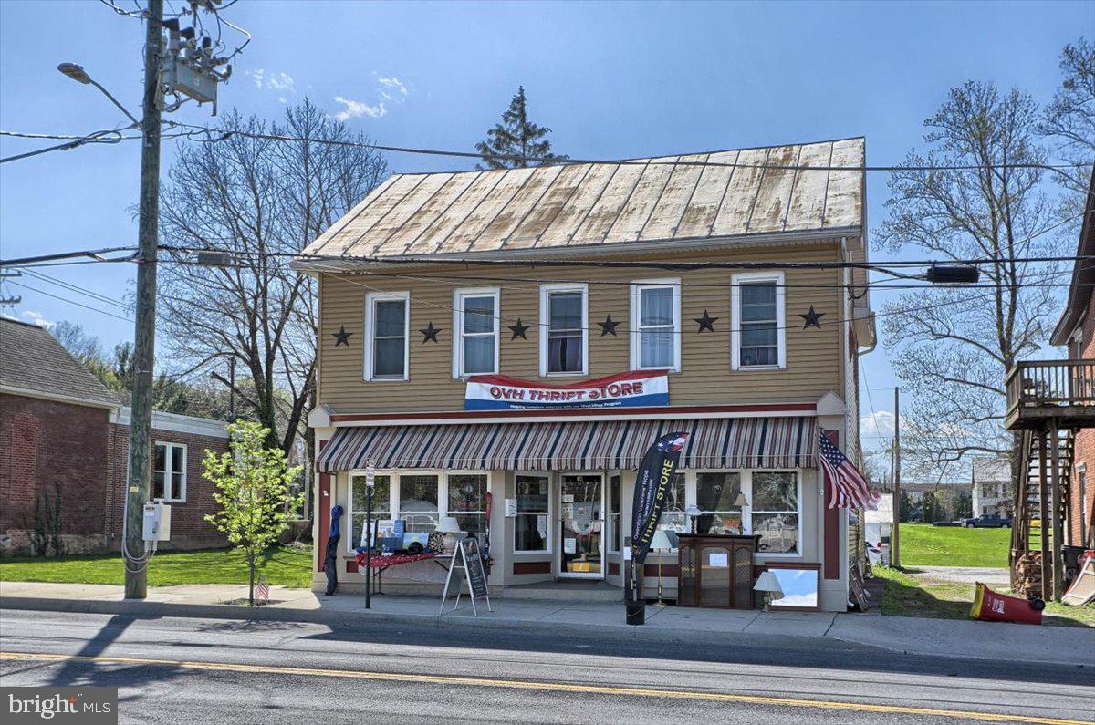 INVESTOR ALERT!!  This property is rented until 12/31/2022.  The current tenant, since 2017, is a 501(c)(3) non profit organization that would love to stay at this location.  They use the entire property and help with the maintenance.  The main level is currently used as a thrift store. It has great road frontage, 2 office areas, bathroom, dressing room, storage areas and front and rear access.  The second level has its own access from a front and rear staircase.  The second level features a kitchen, bathroom, living area, laundry area, and 3 bedrooms.  Pull down attic space provides storage and houses the HVAC for the second floor. The HVAC for the main floor is outside.  Replacement windows, house wrap under the insulation, two 100 amp panel boxes, Borough inspections are every 3 years.  To the rear of the property is a storage unit with electric.  Off street parking for approximately 6-8 cars behind the building and on street parking in front. Please be aware there are cameras on the property.