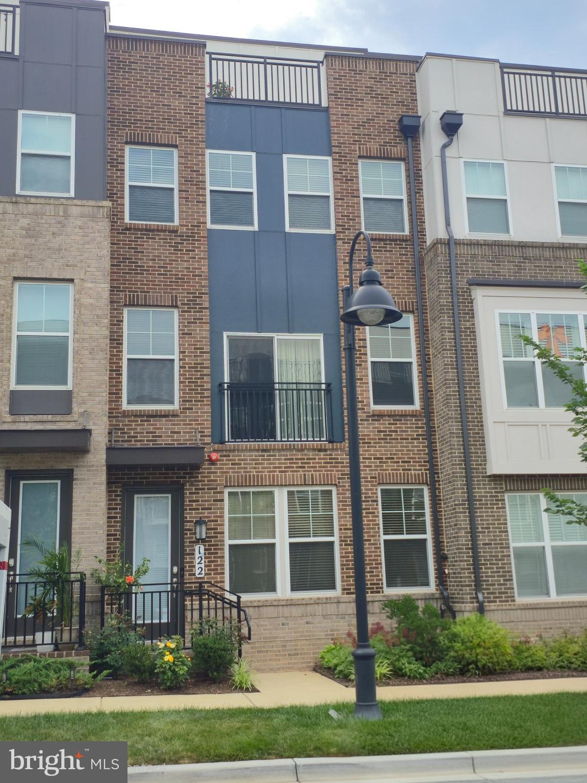 Welcome to 122 Dickenson Drive, where luxury, convenience, and contemporary design come together in the heart of Downtown Crown. Built just four years ago, this impeccably maintained four-level townhome has been thoughtfully enhanced with premium custom upgrades, creating a move-in-ready residence that is as functional as it is elegant.
The entry level featuring a spacious flex room with a full bath—ideal as a guest suite, private office, fitness studio, or additional living space. This level also provides direct access to the attached two-car garage with custom built-in shelving and a pre-installed EV charging outlet.
The main level is designed for effortless living and entertaining, featuring an open-concept floor plan filled with natural light. A beautifully appointed gourmet kitchen anchors the space, flowing seamlessly into the dining and living areas. Just beyond, a private deck provides the perfect setting for outdoor dining, morning coffee, or evening gatherings. A convenient powder room completes the level.
Retreat to the third floor, where the spacious primary suite offers a spa-inspired bath with a towel warming rack and a newly customized walk-in closet designed to maximize both style and organization. Two additional bedrooms provide generous accommodations, including one with a professionally designed custom closet system that adds both elegance and functionality.
The top level is an entertainer's dream. A spectacular bonus living area features a custom-built entertainment center and a beautifully crafted wet bar, creating the perfect space for hosting friends, enjoying movie nights, or relaxing at home. Step outside to the expansive rooftop terrace, an inviting outdoor retreat ideal for dining under the stars or unwinding after a long day. An additional powder room adds convenience to this exceptional level.
Every detail has been thoughtfully considered, including fresh designer-inspired paint, updated window treatments, premium custom storage solutions, and modern finishes throughout.
Perfectly positioned in the vibrant Downtown Crown community, you'll enjoy an unmatched walkable lifestyle with acclaimed restaurants, boutique shopping, cafés, grocery stores, parks, fitness studios, upcoming Crown High School and year-round community events just moments from your front door. Rio Lakefront, major commuter routes including I-270 and I-370, and the ICC are all nearby, providing easy access to Washington, DC, Northern Virginia, and the surrounding Montgomery County area. 122 Dickenson Drive presents a rare opportunity to own an extraordinary home in one of Montgomery County's premier communities.