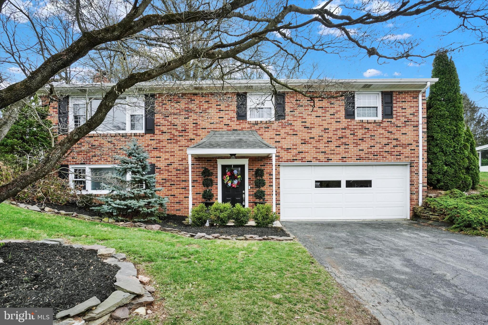 This beautifully modernized brick home is nestled in the highly desirable Arlington Park, within the Dallastown School District! As you step inside, you'll be greeted by an inviting family room featuring a charming wood-burning fireplace. The lower level also includes a spacious storage and laundry room, a convenient half bath, and a versatile space perfect for additional storage, a toy room, or possibly a home office, all with easy access to the garage. Upstairs, you'll find a seamless flow into the living room, enhanced by natural hardwood floors. The updated kitchen is a true standout, offering sleek quartz countertops, stainless steel appliances, a breakfast bar, ceramic tile flooring, and crisp white cabinetry. Sliding doors off the dining area open up to a large, fenced-in backyard, ideal for cookouts and entertaining guests. The upstairs bathroom has been thoughtfully updated with a ceramic-tiled floor and tiled shower. The primary bedroom features a generous walk-in closet, and there are two additional bedrooms, all with convenient hardwood floors. This home offers the perfect blend of updated interior spaces, plenty of room to live and grow, an oversized two-car garage, and lovely landscaping. With no HOA fees, and its close proximity to I-83, schools, restaurants, and shopping, this home is an ideal choice for anyone looking for comfort, convenience, and style.