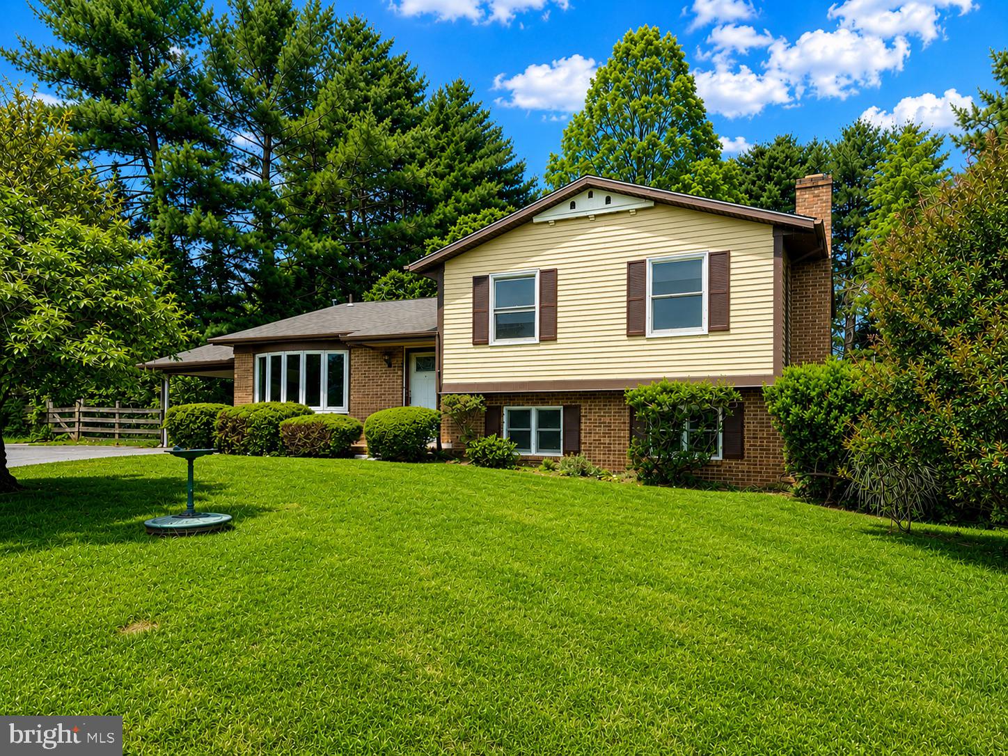 Welcome to this beautifully updated four-level split nestled on a picturesque one-acre lot in the highly desirable Hallmark community. Ideally located just minutes from the Applied Physics Laboratory, Maple Lawn's popular shops, restaurants, and everyday conveniences, this home offers the perfect combination of space, comfort, and accessibility.  Step inside to discover a fresh, modern interior featuring brand-new Luxury Vinyl Plank flooring, new carpeting, and fresh paint throughout. Updated vanities and stylish light fixtures add a contemporary touch while enhancing the home's move-in-ready appeal.  The inviting family room serves as a warm gathering space, highlighted by a classic brick fireplace that creates the perfect setting for relaxing evenings at home. The flexible floor plan includes a private fourth bedroom and full bath, offering excellent options for guests, a home office, or multi-generational living.  The spacious recreation room provides additional living and entertaining space, while the expansive one-acre lot offers endless opportunities for outdoor enjoyment, gardening, recreation, or simply appreciating the peaceful surroundings.  Combining thoughtful updates, generous living areas, and an unbeatable location, this Hallmark home presents a wonderful opportunity to enjoy comfortable living in a sought-after setting.