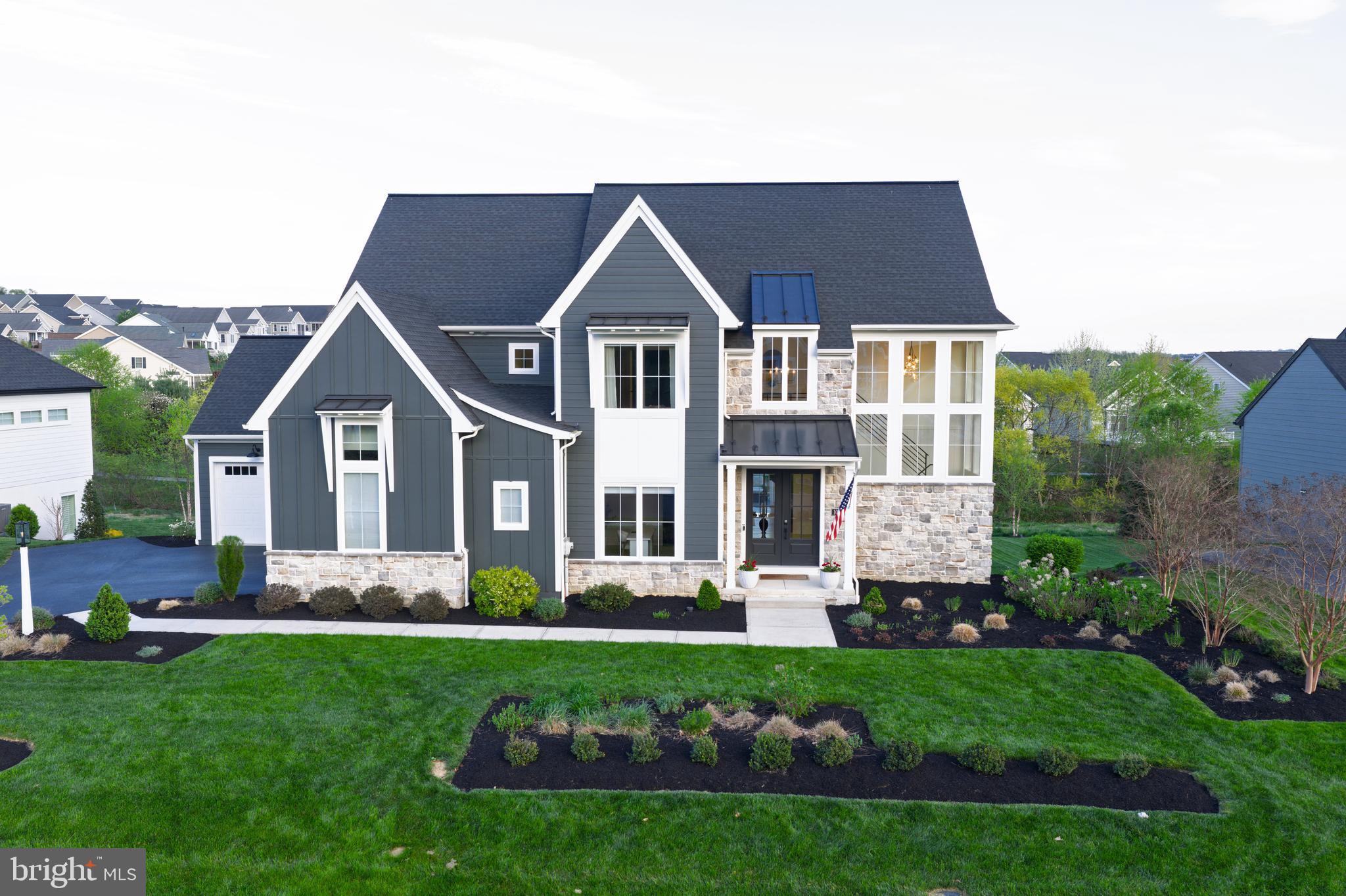 Stunning in design and detail, this 5-bedroom, 4.5-bath home by Pine Hill Building Co. offers a thoughtfully designed layout and exceptional craftsmanship. A striking two-story foyer makes an immediate impression, where a grand staircase framed by wrap-around windows fills the space with natural light and creates a sense of openness from the moment you enter.
The main level is both open and well-defined, anchored by wide-plank white oak flooring, rich wood beam accents, and designer lighting that adds warmth and character throughout. At the center of the home, the chef’s kitchen is designed for both function and gathering, featuring an expansive 10-foot island, quartz countertops, GE Café appliances, and a custom hood accented by detailed tilework. A walk-through scullery and pantry, complete with a second dishwasher, beverage refrigerator, built-ins and floating shelves, offers both convenience and additional prep space, and leads to a well-designed mudroom.  The adjoining family room is highlighted by a linear gas fireplace and a wall of windows, creating a bright, inviting space for everyday living and entertaining. A private home office and first-floor guest suite provide flexibility without compromising design.
Upstairs, the owner’s suite offers a true retreat with a spa-like bath featuring a walk-in tile shower, integrated soaking tub, heated floors, and custom closet built-ins. Additional bedrooms include a private en-suite bedroom and two bedrooms connected by a Jack and Jill bathroom, along with a well-positioned second-floor laundry room.
Architectural details such as custom trim work, and thoughtfully designed built-ins add depth and character throughout the home. Expansive windows and a light-filled dining area lead to the rear deck with steps to the backyard, creating a seamless connection to outdoor living. The daylight lower level offers additional flexibility for future living space. Smart home features, whole-house water filtration, reverse osmosis, water softener, and a security system further enhance comfort and convenience.
3 car garage with a seperate third garage bay featuring a full wall of built-in storage and a slatwall organization system.  Spacious, almost half acre lot. 
This beautifully crafted home offering refined finishes, exceptional natural light, and a well-designed layout in a premier Lititz location close to shopping and everything Lititz has to offer!