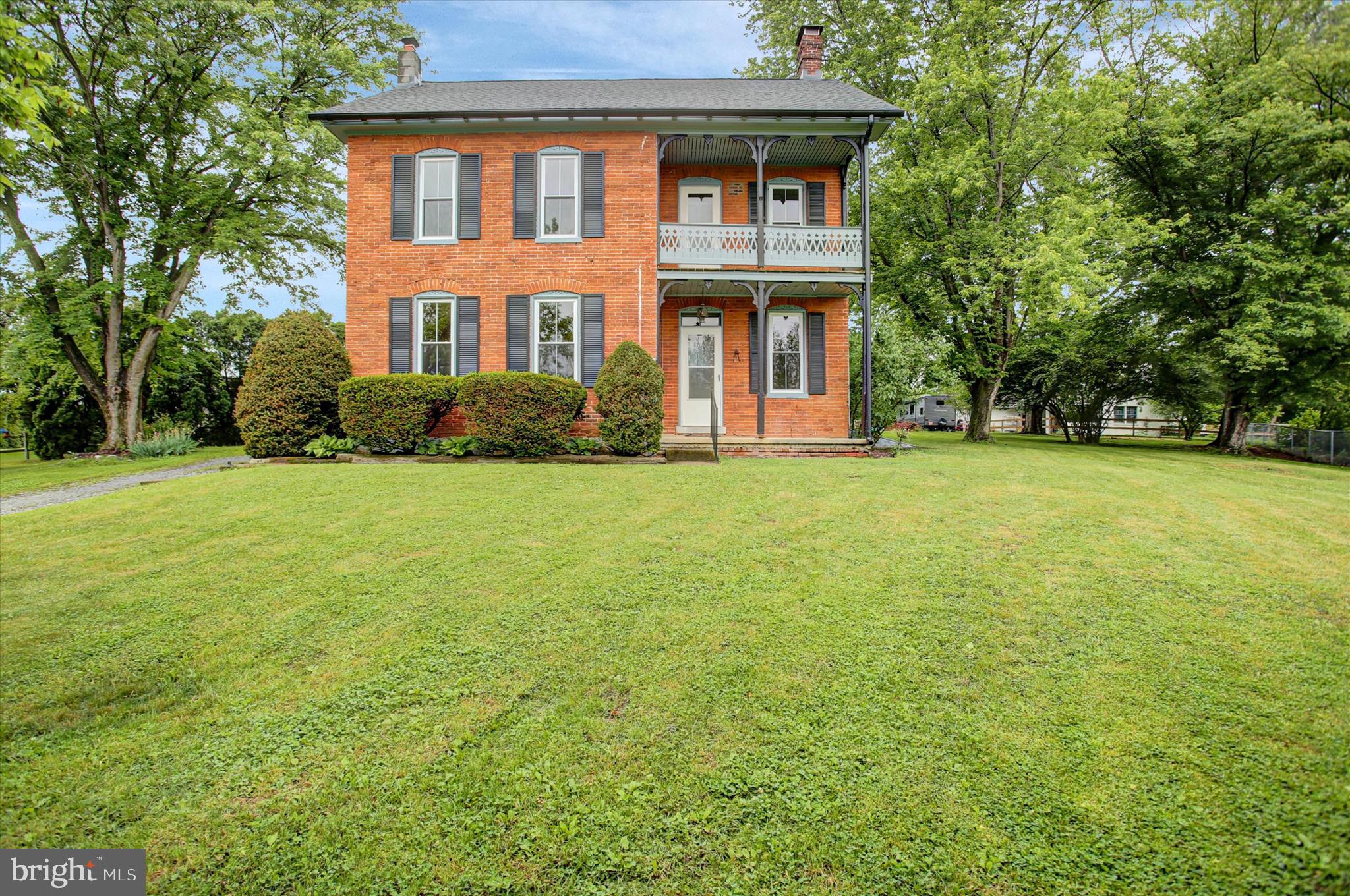 Step back in time and experience all the charm this 1890 farmhouse has to offer. This spacious home features 6 bedrooms and 2 full baths, along with original hardwood floors, soaring ceilings, tall windows filled with natural sunlight, a beautiful brick fireplace, and a cozy sunporch perfect for enjoying every season. Recent updates include new gutters, roof (2026), dishwasher, well pump, water heater, and pressure tank. Conveniently located close to town while still offering a peaceful rural setting. Schedule your private tour today.