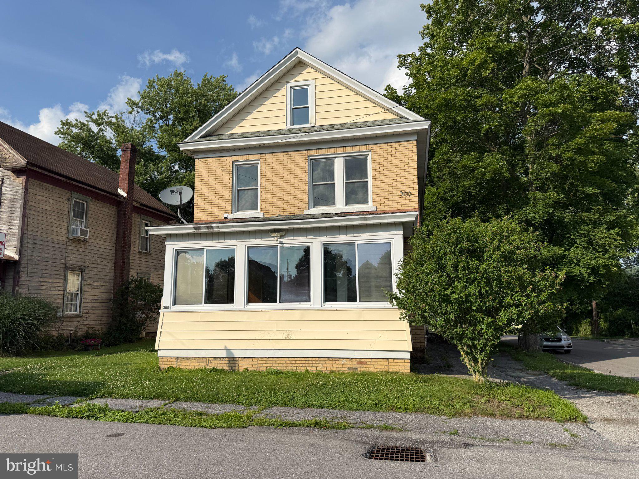 This charming 2-bedroom, 2-bathroom traditional home, built in 1890, offers a unique property for owner occupancy or as an investment opportunity with a blend of classic character and modern amenities. The interior features include original hardwood in the living room, attic with separated areas, and a cozy wood-pellet fireplace, enhancing the home's appeal. The kitchen is equipped with essential appliances: a built-in microwave, dishwasher, electric oven/range, washer, dryer, and refrigerator, making it move-in ready for a new owner or tenants. An oversized detached garage adds value and convenience. With a total finished area of 1,716 sq ft, this home presents a great 1st time home buyer option, or a solid rental income potential in a desirable market. With some vision, and a few upgrades would be a great 1st home, or promising addition to your investment portfolio.