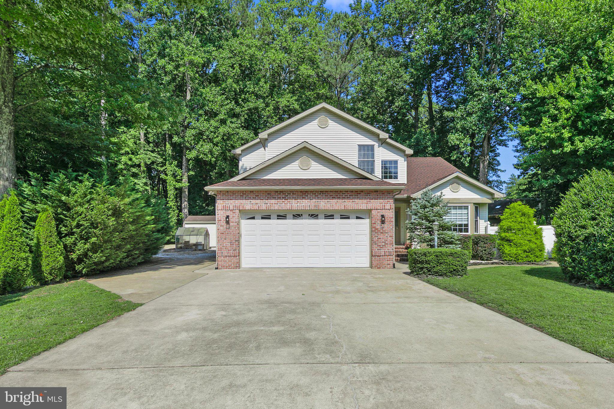 Quality Craftsmanship meets exceptional care in this beautifully maintained home, built by Piney Island Builders. Neatly nestled on a large private lot backing to peaceful woods in the heart of Ocean Pines, this home offers the perfect blend of comfort, privacy, and timeless appeal. Designed for easy living, the home features a spacious first-floor primary suite, providing convenience and flexibility for everyday life. Recent updates include a newer roof, composite decking, and updated kitchen appliances, allowing you to move in with confidence. Step outside and enjoy the beautifully landscaped Backyard, where you'll find a charming treehouse and plenty of space to relax, entertain, or simply take in the serene wooded setting. A large garage offers ample room for vehicles, storage, and hobbies. Two more outbuildings, a large shed, and an adorable greenhouse complete the yard. This exceptional home showcases quality construction, thoughtful updates, and a peaceful setting -making it a wonderful opportunity to enjoy all that Ocean Pines has to offer
