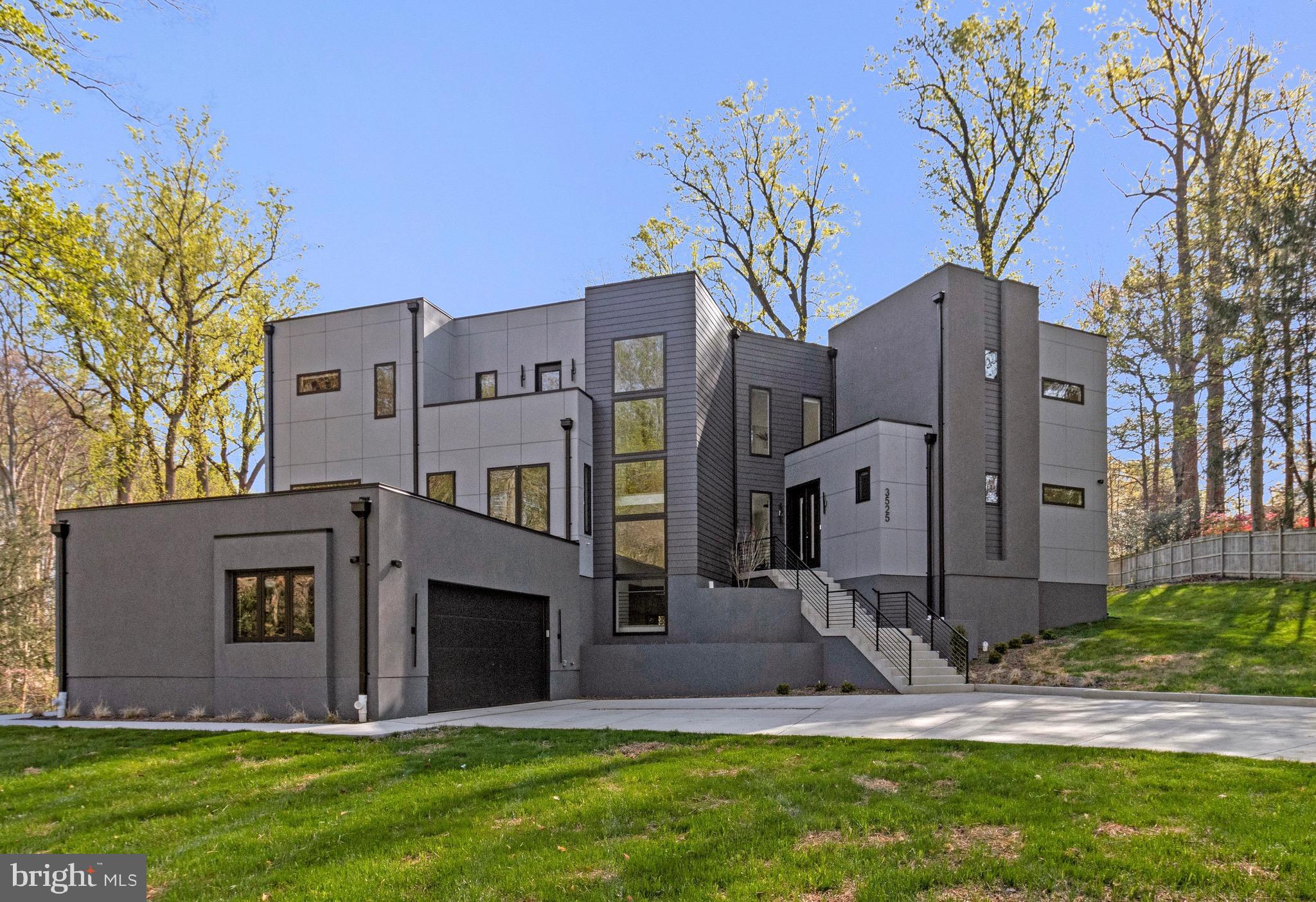 Custom-built and completed in November 2025, this stunning contemporary residence is tucked away on a quiet cul-de-sac in sought-after Mantua on a premium one-acre lot. Surrounded by distinctive upscale homes, the property offers a rare combination of modern style, quality construction, and a tranquil setting. Designed for comfort and flexibility, the home includes an elevator providing easy access to all three finished levels.

On the main level there are 10' ceilings, and the light-filled living room showcases a fireplace and dramatic floor-to-ceiling windows overlooking the back yard. The adjacent gourmet kitchen, complemented by an enormous pantry/prep kitchen, creates a true chef’s paradise. Upscale appliances:  Sub zero refrigerator, Wolf oven, Wolf steam oven/microwave, 6 burner stove with griddle Dacor, Cove dishwasher,  and Sub Zero freezer drawers.  This level also includes a separate dining area, private office, meditation room, guest bedroom with full bath, powder room, and a  balcony ideal for outdoor entertaining. The entry/lower level features an exceptional in-law or au pair suite with its own living area, kitchenette, and 2nd laundry room, offering the potential for fully independent living. Additional bedrooms 5 & 6, Exercise-gym or flex room with ensuite bathroom.  

Upstairs, the luxurious primary suite offers a spacious custom shelving walk-in closet and spa-inspired bath. A second primary suite and an additional upper-level bedroom with en-suite bath provide excellent space and privacy for family or guests. Laundry room on upper level.  Additional highlights include a side-loading 2-car garage, expansive fenced yard, full-yard irrigation system, and quality exterior materials including HardiPanel, lap siding, and stucco.  Thoughtfully laid out trees at the rear have been planted to provide greenery and privacy and fringe the perimeter.  Plenty of room exists for lawn, gardens and to add an in ground pool if next owners would like.  A 1-year builder’s limited warranty for workmanship and materials remains in effect through November 5, 2026, along with a 10-year structural warranty.  This home has been wired for a generator should next owners want to install one. 

This modern custom stylish  home  has approximately 6,400 finished square feet, 6 bedrooms, 6.5 baths and  is located just outside the beltway and close to other major commuting routes :  I-66, I-395, 29 and 50.  Dunn Loring and Vienna Metros close by.  Fairfax Hospital just 5-8 minutes drive.  The wonderful Mosaic shopping center with its Farmers market, shops and restaurants is nearby.  Mantua neighborhood offers a Swim and Tennis Club, many clubs and activities and a great sense of community.  Woodson HS.