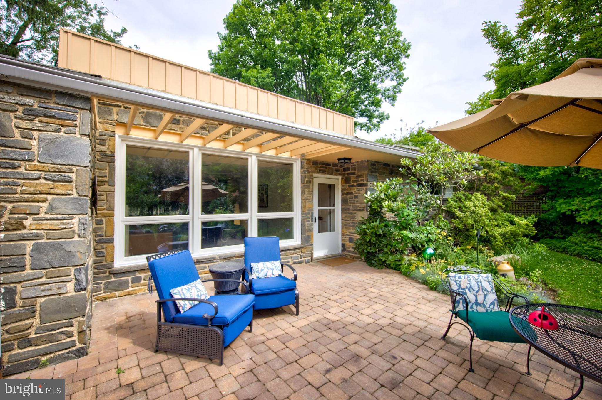 Midcentury gem in idyllic Mount Airy location. Lushly landscaped front and rear yards Attached 1 car garage with storage. One story 3 bed 2 Bath home with Oak floors throughout Bright open living room with Wissahickon schist wall feating a fireplace Separate dining area with greenhouse window. Older kitchen with stainless steel appliances including 5 burner gas range and microwave with externally vented exhaust. Hand painted cabinet pulls. Laundry room and mechanical off the kitchen.
Primary suite has en suite tile bath. Hall tile bath. 3rd bedroom has had an addition that was used as an art studio.  Doggy door to fenced area of yard from the studio.
Less than 2 blocks to the Mt. Airy commuter rail. Close to all the wonderful shops and restaurants of Mt. Airy and Chestnut Hill.
