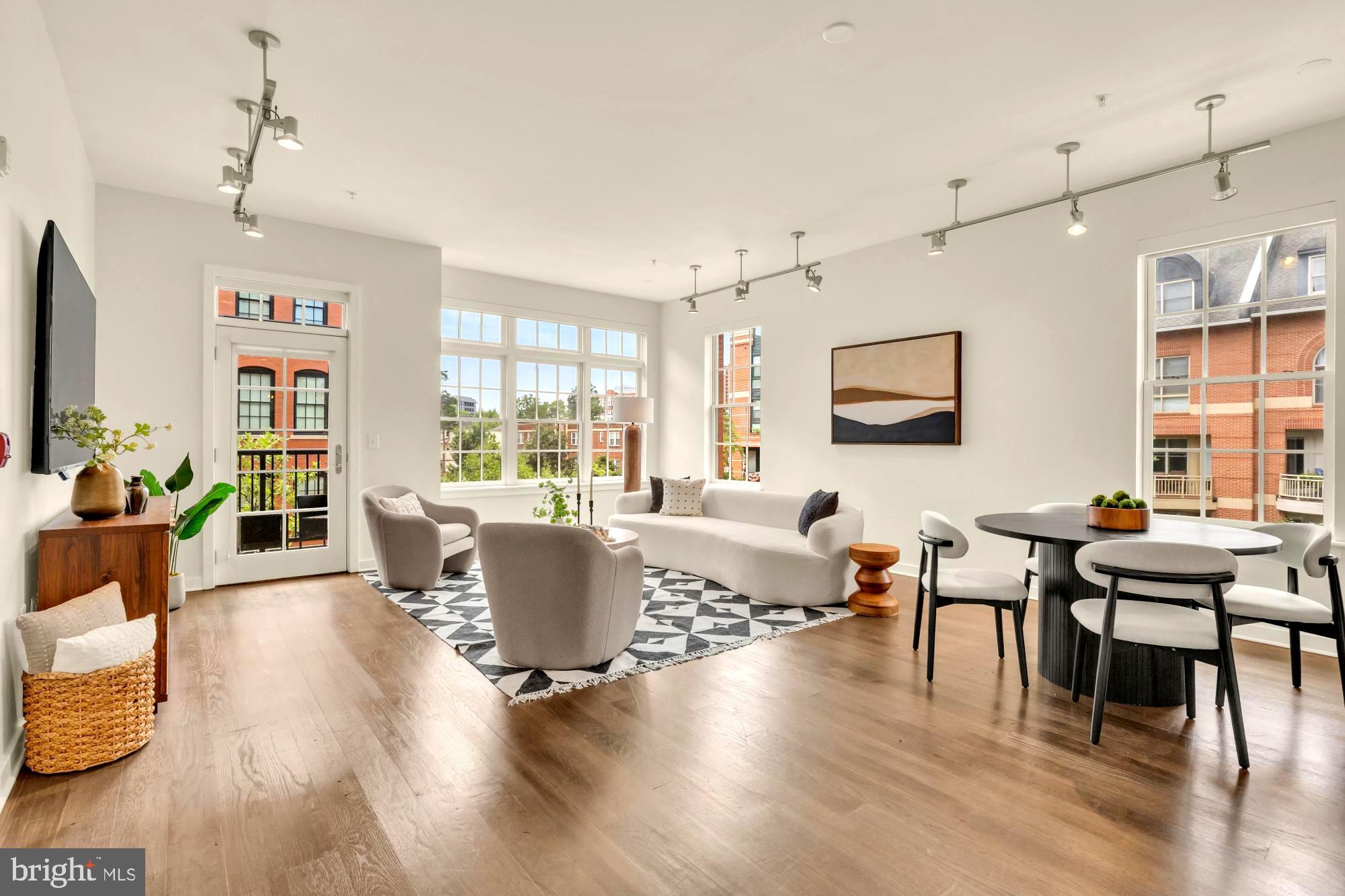 Welcome to refined living at Gaslight Square, one of the most sought-after residences in Arlington and the entire DMV. This sophisticated Soho-style end unit offers direct elevator entry, three exposures, oversized windows, and a bright, open layout designed for effortless entertaining.
The gourmet kitchen features a WOLF range, 36-inch Sub-Zero refrigerator, ASKO dishwasher, quartz countertops, custom cabinetry, and an expansive island. The home has wood floors throughout, while the luxurious primary bath showcases dual vanities, a glass-enclosed shower, and Porcelanosa tile.
Enjoy a private balcony, generous storage, and an oversized ADA garage space. Ideally located between Rosslyn and Courthouse Metro, just moments from Clarendon, Wilson Boulevard, and DCA. Parking space is (#164).