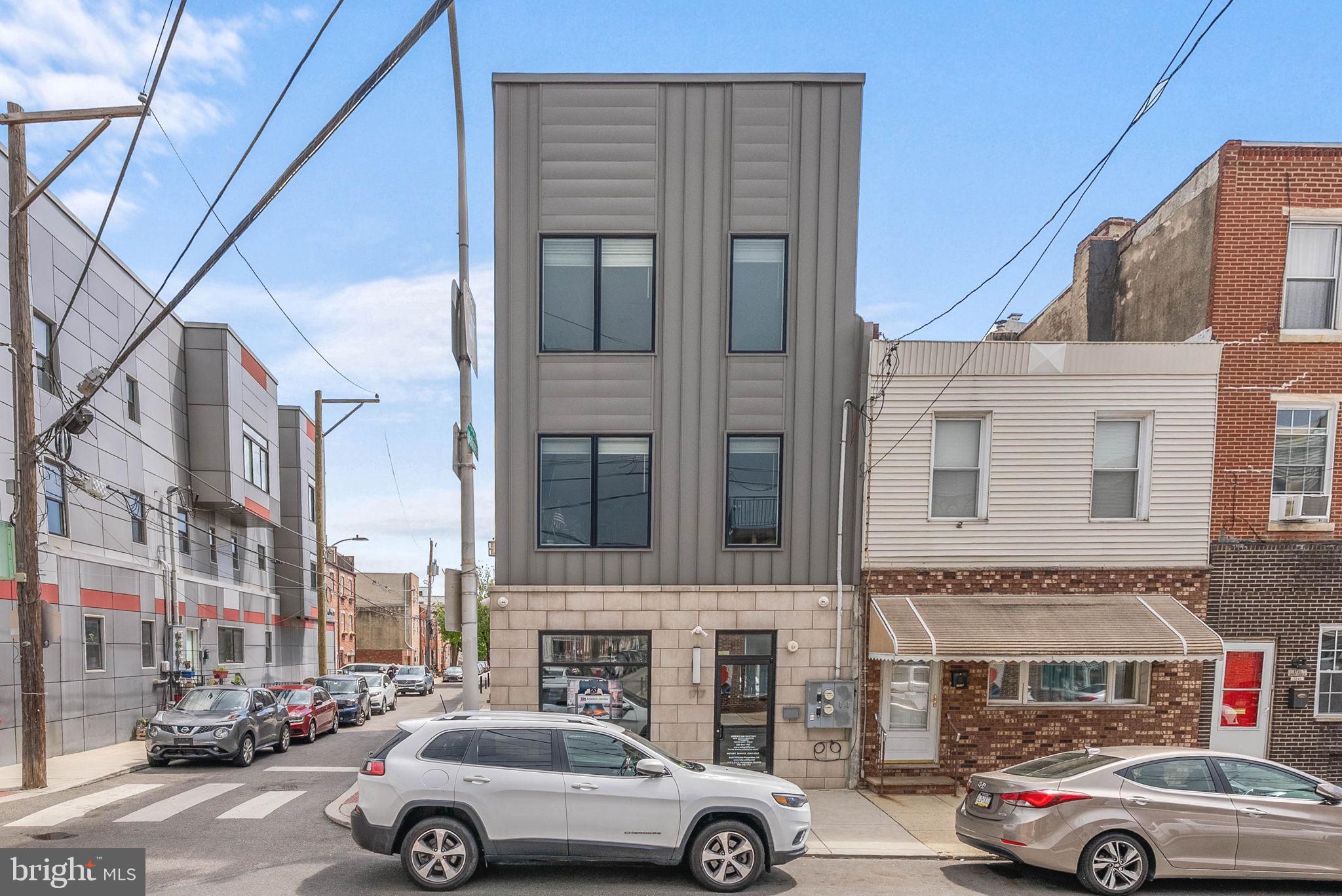 An exceptional opportunity to live and invest in the heart of Pennsport! This versatile mixed-use property offers the best of both worlds plus comes with a tax abatement (ends 12/31/31), PARKING for 2-3 vehicles, Sonos and so much more! Enjoy a beautifully designed residence while generating income from the street-level commercial space. The residential portion spans the second and third floors, featuring a bright, open-concept layout perfect for modern living with fireplace. The expansive living area flows seamlessly into a stunning kitchen complete with a large center island providing additional seating. Just beyond, a dedicated dining space opens to a private balcony. The spacious primary suite offers a peaceful retreat with its own en-suite bath, while a second bedroom and full hall bathroom provide flexibility for guests, a home office, or additional living space as well as upper floor laundry. Upstairs, your private roof deck awaits providing an incredible space for entertaining or unwinding while taking in city views. On the ground level, the thoughtfully designed commercial space is currently leased through 9/30/26, offering immediate rental income with future flexibility. Ideal for a boutique retail shop, office, or café concept, the space benefits from excellent visibility and steady foot traffic, with a dedicated front entrance and convenient rear access. Situated just steps from neighborhood favorites like 2nd Street Brew House, Starbucks, Target, and all the shopping and dining along Columbus Avenue, this is a rare opportunity to own a dynamic property in one of Philadelphia’s most vibrant neighborhoods. Taxes and square footage to verified by the buyer independently.