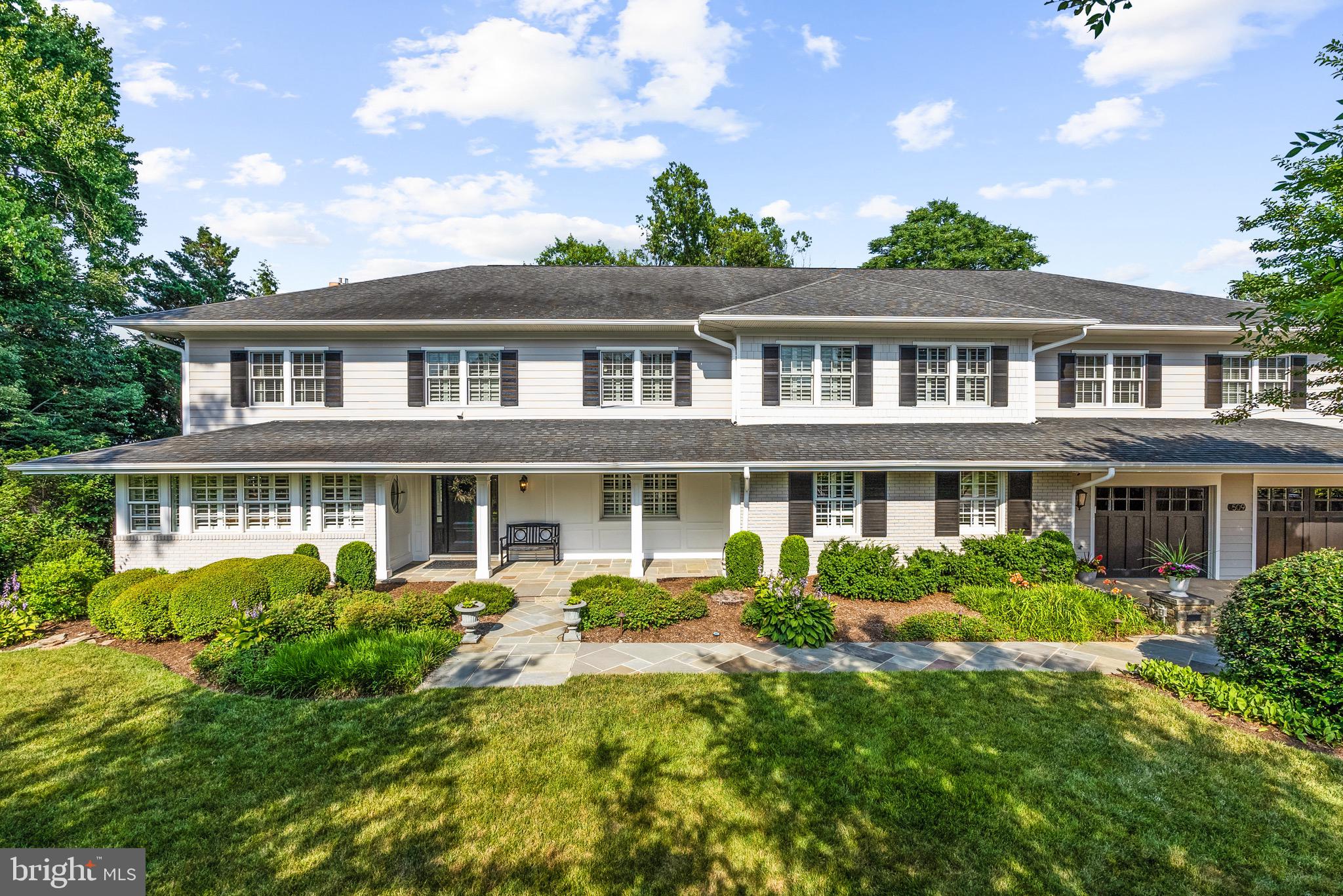 Welcome to this renovated and expanded Colonial offering 6,500 finished square feet of beautifully designed living space on a nearly half acre lot. Blending timeless architecture with extensive modern updates, this six-bedroom, five-and-a-half-bath residence is a rare opportunity to enjoy luxury living, remarkable indoor-outdoor entertaining spaces, and unparalleled convenience.

The heart of the home is the inviting backyard retreat - a private outdoor oasis featuring a heated swimming pool, spa, tranquil pond, extensive professional landscaping, stone walls, patios, and a fully fenced yard designed for both relaxation and entertaining. Whether hosting summer gatherings or enjoying a quiet evening outdoors, the setting feels like a private resort.

A welcoming front porch leads to gracious interior spaces thoughtfully designed for everyday living and special occasions. The main level features elegant formal living and dining rooms, including a sophisticated dining room with coffered ceilings, a handsome library with custom built-ins, and a comfortable family room with built-ins, gas fireplace and sliding glass doors opening to the backyard. The sun-filled breakfast room showcases vaulted ceilings and walls of windows overlooking the grounds, with direct access to outdoor living spaces.

The gourmet kitchen is equipped with custom inset cabinets, a breakfast bar, stainless appliances including a Viking gas cooktop, double ovens, a warming drawer, and abundant storage. A butler’s pantry provides seamless access to both the dining room and backyard entertaining areas, while a large pantry with California Closet built-ins offers exceptional organization. Additional main-level amenities include a private home office, mudroom with built-in cubbies, powder room, and a full bathroom conveniently accessible from the pool.

Upstairs, the expansive primary suite serves as a luxurious retreat, featuring soaring ceilings, a sitting area, private balcony overlooking the backyard, custom walk-in closet, and a newly renovated spa-inspired bath complete with a soaking tub, glass-enclosed shower, double vanity, and dedicated makeup vanity. Evenings provide seasonal twinkling views of the Masonic Temple and National Harbor beyond. Three additional bedrooms and two full baths complete the upper level, including an impressive in-law or guest suite with its own bedroom, living area, kitchenette, and direct access to the balcony.

The fully finished walk-out lower level offers outstanding flexibility with a spacious recreation room, full wet bar with sink, two beverage refrigerators, an additional bedroom, beautifully renovated full bath, generous storage space, and French doors leading to the private fenced side yard. 

Car lovers, hobbyists, and fitness enthusiasts will appreciate the approximately 1,000-square-foot garage accommodating up to four vehicles while still providing space for a home gym or workshop. The large driveway and additional parking pad offer room for six or more additional vehicles - a truly rare feature in Alexandria.

Ideally located close to Old Town Alexandria, parks, schools, shopping, dining, and major commuter routes, this extraordinary property combines luxury, comfort, and convenience in a setting that is simply unmatched. A one-of-a-kind Alexandria residence where exceptional indoor living meets resort-style outdoor living.