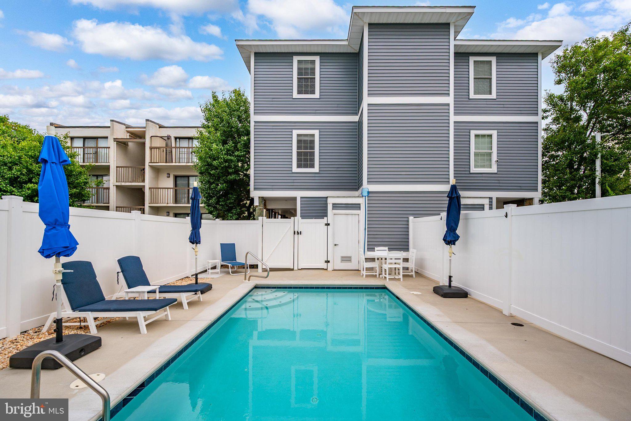 Luxury Ocean Block Townhome with Private Heated Pool, Elevator & Proven Rental Income! Built in 2022, this fully furnished ocean block 4BR/5BA luxury townhome, with no HOA or condo fees, offers ocean views, a private heated pool, private elevator, a large finished loft, ample covered parking, and an impressive $158,000 in annual gross rental income – all just steps from the beach at 80th Street. This beautifully appointed four-level residence offers over 2,700 square feet of thoughtfully designed living space and is being sold fully furnished and totally equipped as a true turnkey home or rental property. Ideally situated on the 80th street ocean block, the home is a short walk to one of Ocean City's less crowded beach accesses. It provides the perfect setting for relaxing beach days while remaining close to popular restaurants, shopping, entertainment, and the attractions that make Ocean City a premier vacation destination.  Designed to accommodate big families and groups with ease, the open-concept floor plan features a stunning gourmet kitchen with an oversized island, abundant cabinetry, two dishwashers, and a dry bar with an ice maker and two beverage refrigerators. The adjoining dining and living areas provide generous gathering space, while a spacious furnished deck offers ocean views. Additional features include three-zone HVAC, a high-capacity laundry room, and high-speed internet. The home features four spacious bedrooms, a large finished loft, and five full bathrooms. Each bedroom and the loft offer a smart TV, ceiling fan, blackout shades, and ample closet space. The primary suite includes a dedicated workspace and a private balcony with ocean views. A private elevator provides convenient access to the first three levels, while the fourth-floor loft creates additional living and recreation space.  Outdoor amenities are equally impressive and include a private heated swimming pool exclusive to the residence, a fully enclosed outdoor shower, beach gear storage, and an outdoor grilling area featuring a Weber grill. As a newer construction property, this home offers modern systems, high-end finishes, and low-maintenance ownership. Currently operating as a highly successful weekly Saturday-to-Saturday vacation rental, the property generates approximately $158,000 in annual gross rental income, making it an exceptional opportunity for investors seeking immediate cash flow and strong rental demand.  Whether you're searching for a luxury beach retreat, a second home, or a premier income-producing investment property, 13 80th Street delivers an unmatched combination of location, amenities, and rental performance. Come take a look before it's sold!