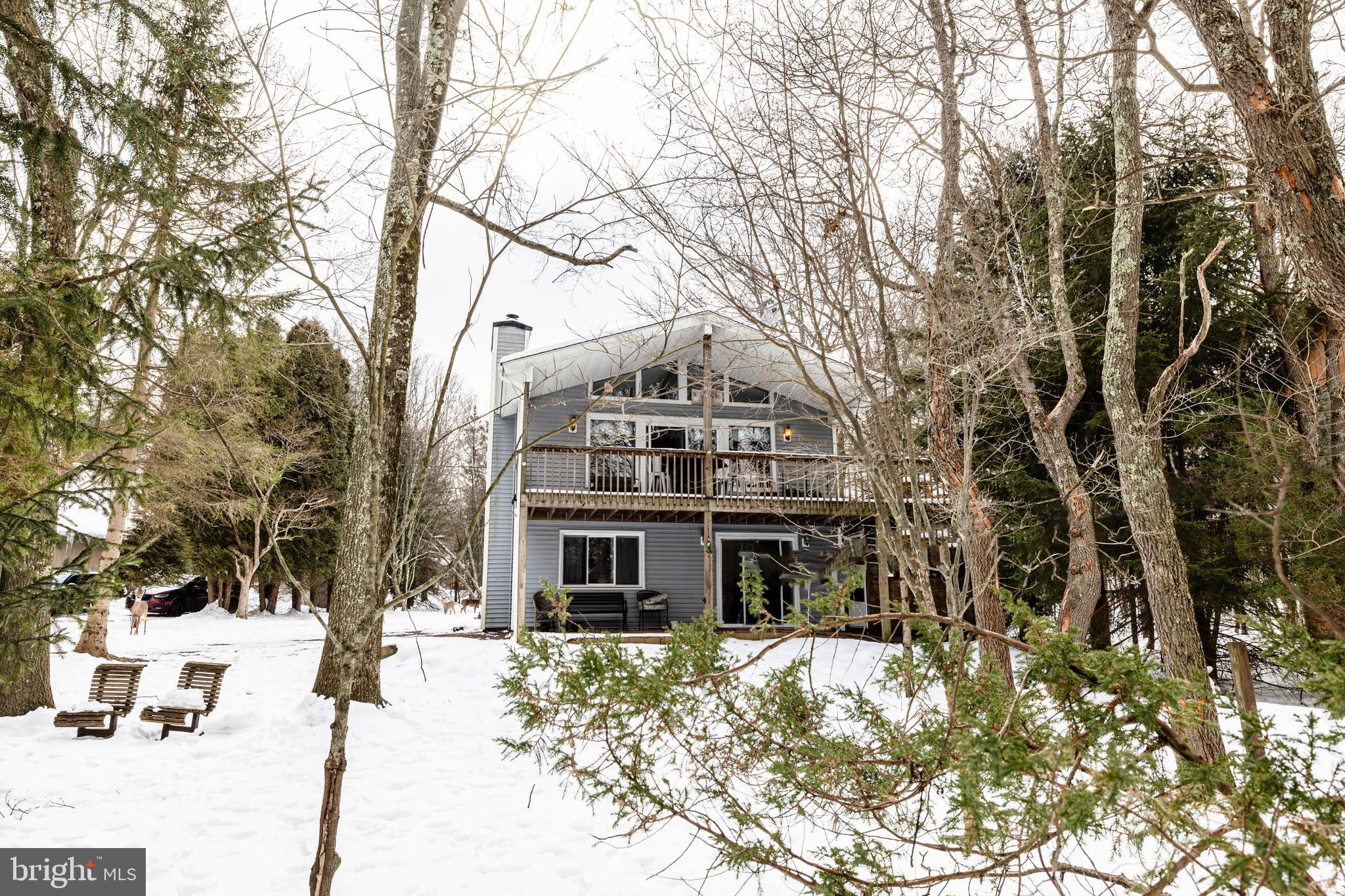 Welcome to your dream retreat! This spacious 4-bedroom, 2-full bath home nestled in a private community. Unwind in the outside hot tub or cozy up to one of the two wood-burning fireplaces, each on a different level. The lower level boasts a game area with a convenient kitchenette. Enjoy the breathtaking surroundings from the wrap-around deck on the second level. STR friendly and fully furnished for your convenience. Commute effortlessly to New York, New Jersey, and the Philadelphia Area, and relish quick access to Big Boulder Ski Resort, White Water Rafting, and Golf—all just minutes away. This private community offers a beautiful lake, beach, swimming pool, ATV trails, tennis courts, basketball courts, and more. Surrounded by State Game Lands, this is a paradise for hunting and fishing enthusiasts. Don't miss this opportunity to embrace a lifestyle of comfort and recreation!