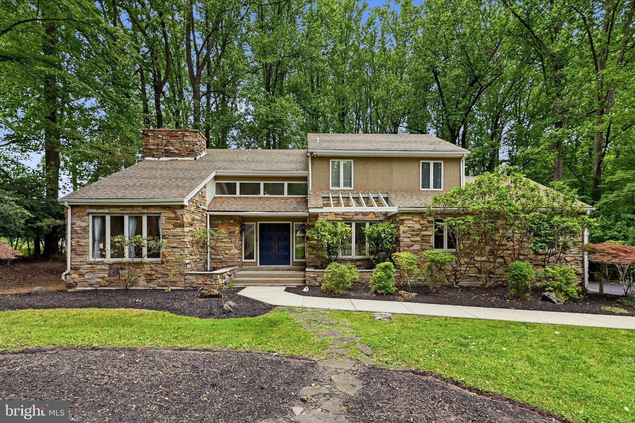 Tucked away on a private 1.4-acre cul-de-sac lot just minutes from the heart of West Chester Borough, this distinctive stone-front contemporary offers a rare blend of architectural character, wooded privacy, and everyday convenience. Soaring ceilings, expansive windows, exposed beams, and a dramatic double-sided stone fireplace create a warm and inviting atmosphere throughout the home. 

The spacious kitchen flows seamlessly to the dining room and opens to a large deck overlooking the private, tree-lined backyard. Thoughtfully maintained and updated throughout, recent improvements include a newer HVAC system, updated flooring, fresh interior paint, new carpeting, a renovated primary shower, updated kitchen appliances, and a new hot water heater.

Upstairs, the owner's suite features a striking stone accent wall, walk-in closet, and private bath, while three additional spacious bedrooms and a hall bath provide plenty of room for family and guests. An expansive unfinished basement offers endless possibilities for future living space, recreation, or storage. 

Located in the award-winning West Chester Area School District, this is a rare opportunity to own a truly unique home in a neighborhood where homes rarely become available.