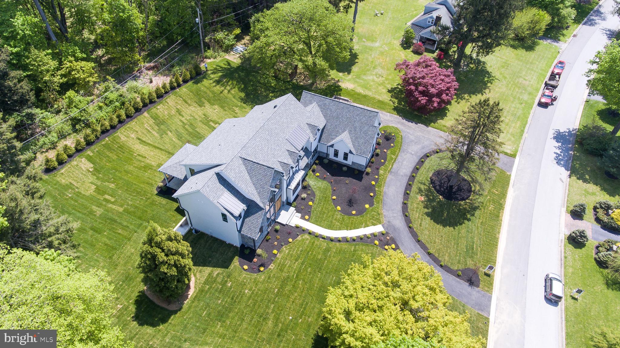 BEST OF THE MAIN LINE Radnor Township Chic  New Construction!  Set for August Delivery and masterfully built on an expansive 1 acre Level lot in Bryn Mawr, this home's fresh Modern aesthetic is unmatched.  This spacious 5 Bedroom home marries the grandeur of a traditional Main Line Estate with a floor plan that is mindful of modern living. The black Iron double entry door leads to a grand foyer with 20" ceilings, quarter sawn white oak herringbone floors and an impressive staircase flanked by floor to ceiling windows. The home features 10' ceilings on every floor as well as a large main floor office/bonus room and expansive family room with views of the property.  Ideal for effortless entertaining the Gourmet kitchen features hand made Craft Maid custom cabinetry, Thermador appliances, and adjacent Butlers Pantry.  The main floor opens to a covered patio and sprawling back yard large enough for a pool and poolhouse.  The 2nd floor has 5 large bedrooms, laundry room and a fabulous Master with vaulted ceilings and luxurious en suite bathroom with heated floors, Porcelanosa tile and a large freestanding soaking tub.   The optional finished basement features another 2500 square feet of possible living space and can accommodate a wine room, large media/ theatre room as well as an in-law or au pair suite..  Located in award-winning Radnor School District but close to all prestigious Private schools, Downtown Bryn Mawr, and all the fabulous shopping and dining of the Main Line.  A quick commute to Center City  Philadelphia, Wilmington, Valley Forge, and the International Airport,  This is the home you didn't think existed but definitely the one you've been waiting for.
