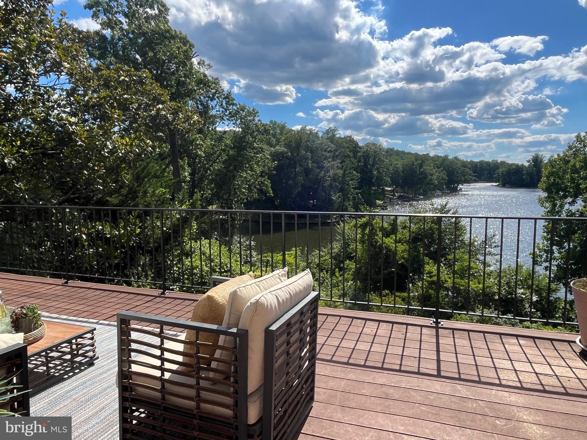 LAKE BARCROFT WATERFRONT | SPECTACULAR VIEWS!

Set on a quiet cul-de-sac, this waterfront mid-century modern offers some of the most breathtaking views in Lake Barcroft. Sited on nearly half an acre, the 4BR/3BA home combines a prime waterfront setting, expansive lake views, and the opportunity to create something truly special.

Designed to showcase the scenery, the light-filled main level offers panoramic lake views, hardwood floors, and multiple skylights. The sunny, spacious living room features a stone fireplace, a huge picture window overlooking the water, and recessed lighting. The separate dining room addition offers built-ins and sliding glass doors opening to an expansive deck—perfect for morning coffee, sunset dinners, or gathering with friends to enjoy Lake Barcroft's famous fireworks.

The renovated eat-in kitchen features high-end European-style cabinetry, stainless steel appliances including a Bosch dishwasher and KitchenAid oven, a large island, and an oversized skylight. The attached carport provides convenient access directly into the kitchen. Three spacious bedrooms and two baths are located on the main level, including an ensuite primary bedroom. 

The walkout lower level offers exceptional flexibility. The oversized family room features, luxury vinyl plank floors, a gas fireplace, wet bar, and a large picture window framing the lake views. A bonus room provides space for a home office, exercise studio, or hobbies. The expansive second ensuite bedroom feels like a private retreat, complete with extensive built-ins, a sitting/dressing area, large walk-in closet, and a wall of windows overlooking the backyard and lake.  The lower level also offers a large laundry room and abundant storage throughout.

The spacious backyard and exceptional waterfront setting truly set this property apart. Follow the path down to the expansive dock with plenty of room for kayaks, paddleboards, a pontoon boat, and all your lake toys. Spend your days swimming, fishing, paddling, or simply relaxing by the water and taking in the spectacular views. Lake Barcroft residents enjoy five private sandy beaches, year-round community events, and an active outdoor lifestyle, all just minutes from East Falls Church Metro, Arlington, Tysons, and Washington, DC.

Whether you choose to enjoy the home as it is, renovate to suit your style, opportunities like this are increasingly rare. With sweeping lake views, a quiet cul-de-sac setting, direct waterfront access, and endless potential, this is a chance to own one of Lake Barcroft's most coveted combinations of location and lifestyle.

Note: Professional photos, video, floor plans, and 3D tour to be uploaded Tues, June 23.