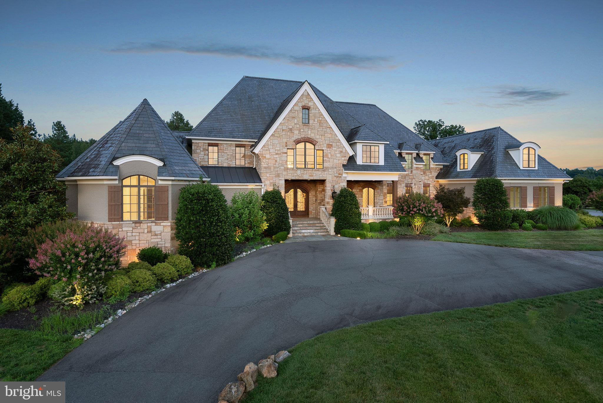 Standing proudly on 3.32 acres of impeccably landscaped grounds, this remarkable Creighton Farms estate offers the idyllic country club living of your dreams! Stately and imposing, the residence possesses an impressive curb appeal that’ll make you a proud homeowner. With 9 bedrooms, 7 full baths, 3 half baths, and multiple gathering areas to choose from, this home is perfect for entertaining on a large scale. The winding drive entices you to this magnificent gem where an elevated front porch lures you through the grand entry. An awe-inspiring foyer receives you where fine craftsmanship and admirable attention to detail are evident everywhere from the moment you arrive.

Elegant marble and hardwood flooring gleam under the high ceilings soaring over the main gathering areas. The regal fireplace adorns the formal living room, along with arched French doors connecting to the sunlit patio. Sensational meals await in the dining room defined by exquisite wainscoting, elaborate crown moldings, and stylish chandeliers. Inspired by magazines, the chef-centric kitchen displays top-of-the-line appliances, including a stainless steel Wolf range, a commercial-size refrigerator, and a freezer. You’ll love conversing with guests over the large, multi-seater island as you concoct your signature dishes. Bespoke Habersham cabinetry, rich countertops, and a walk-in pantry complete this opulent culinary space.

As you end the day, there are plenty of options for a comfortable respite distributed across various levels. Double doors reveal two exceptional primary suites that offer main-level comfort and convenience, graced with fireplaces, seating areas, and exclusive patios. Luxurious 5-piece ensuites adjoin these bedrooms, highlighted by dual vanities, separate showers, and spa-like soaking. Crafted for the ultimate in personal diversions, the lower level is designed with everything you need to relax. Spend game and movie nights in the media room with one of the three full-size wet bars to shake up your favorite cocktails. A golf simulator room and a gym allow you to stay active even indoors.

Breathtaking backdrops surround you when venturing out to the patio overlooking the rest of your acreage - the ideal spot for intimate alfresco dining or blissful weekend celebrations. Sip morning beverages as you enjoy the peaceful and serene surroundings of this exclusive community. Other notable perks include a luggage closet and two laundry rooms, ensuring all your storage needs are met. Additionally, there are multiple attached garages and an extended driveway for added parking. Ready for the extraordinary lifestyle most people only dream of? Come take advantage of this one-of-a-kind opportunity and enjoy all that Creighton Farms has to offer.