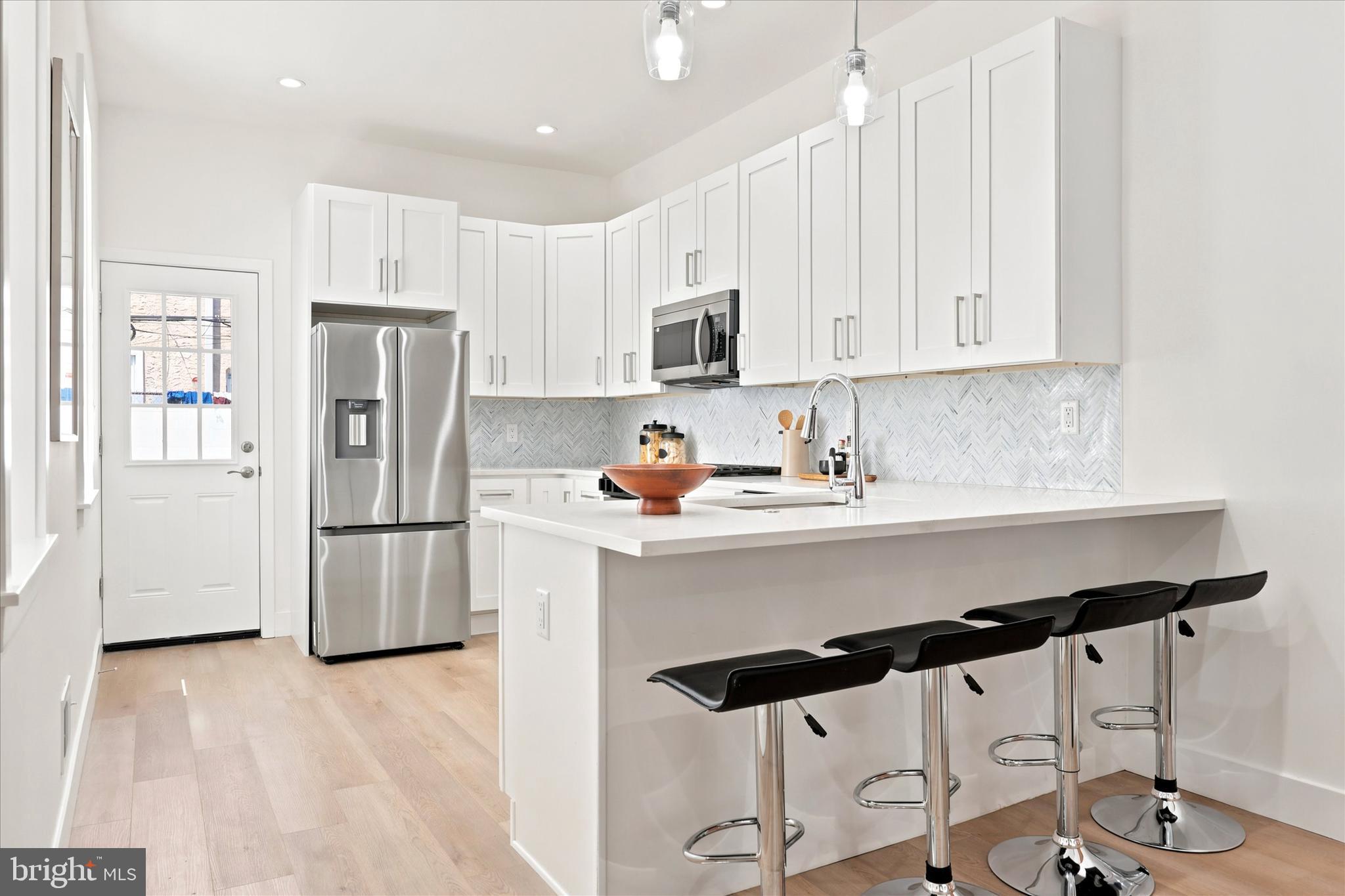 Completely rebuilt from top to bottom, this stunning home seamlessly blends modern luxury with classic Philadelphia character. Thoughtfully renovated throughout, the property features a newly added third story and roof deck, a fully excavated finished basement offering valuable additional living space, and high-end finishes at every turn. The sun-drenched open-concept main level showcases wide-plank flooring, exposed brick, sleek black accents, and a designer kitchen with quartz countertops, stainless steel appliances, and custom cabinetry. Spacious bedrooms, beautifully appointed bathrooms, generous closet space, and abundant natural light create a comfortable and sophisticated living experience. Outside, enjoy a rare oversized private patio—perfect for entertaining, gardening, or relaxing. Ideally situated just moments from Passyunk Avenue's acclaimed restaurants, cafes, boutiques, and nightlife, as well as Center City shopping, Rittenhouse Square, the Broad Street Subway, and convenient access to I-76 and I-95, this turnkey home offers the perfect combination of style, space, and location. Photos and showings are coming soon.