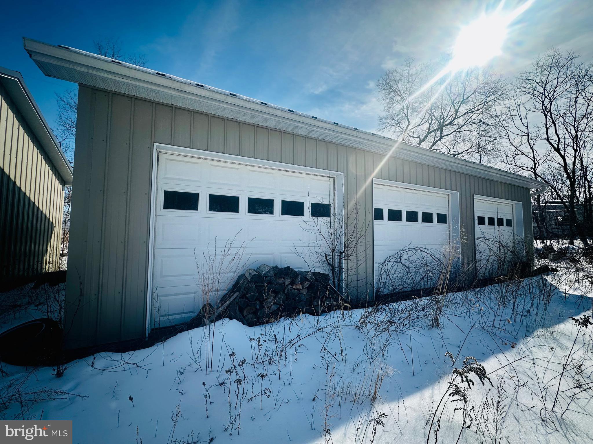 Perched at the top of the street with scenic views overlooking the Cumberland Airport and the City of Cumberland, this property offers two oversized garage buildings ready for their next owner. The garages include a two-bay unit (24x24) and a three-bay unit (40x24), both built by Featherbuilt and previously used for storage.

The property is equipped with 200-amp electric service and an RV hookup already in place. Public water and sewer are available at the property, offering future expansion possibilities if desired.

With ample space, the lot also provides the opportunity to add a tiny home or trailer, making this a versatile investment for storage, hobby use, or potential residential setup.