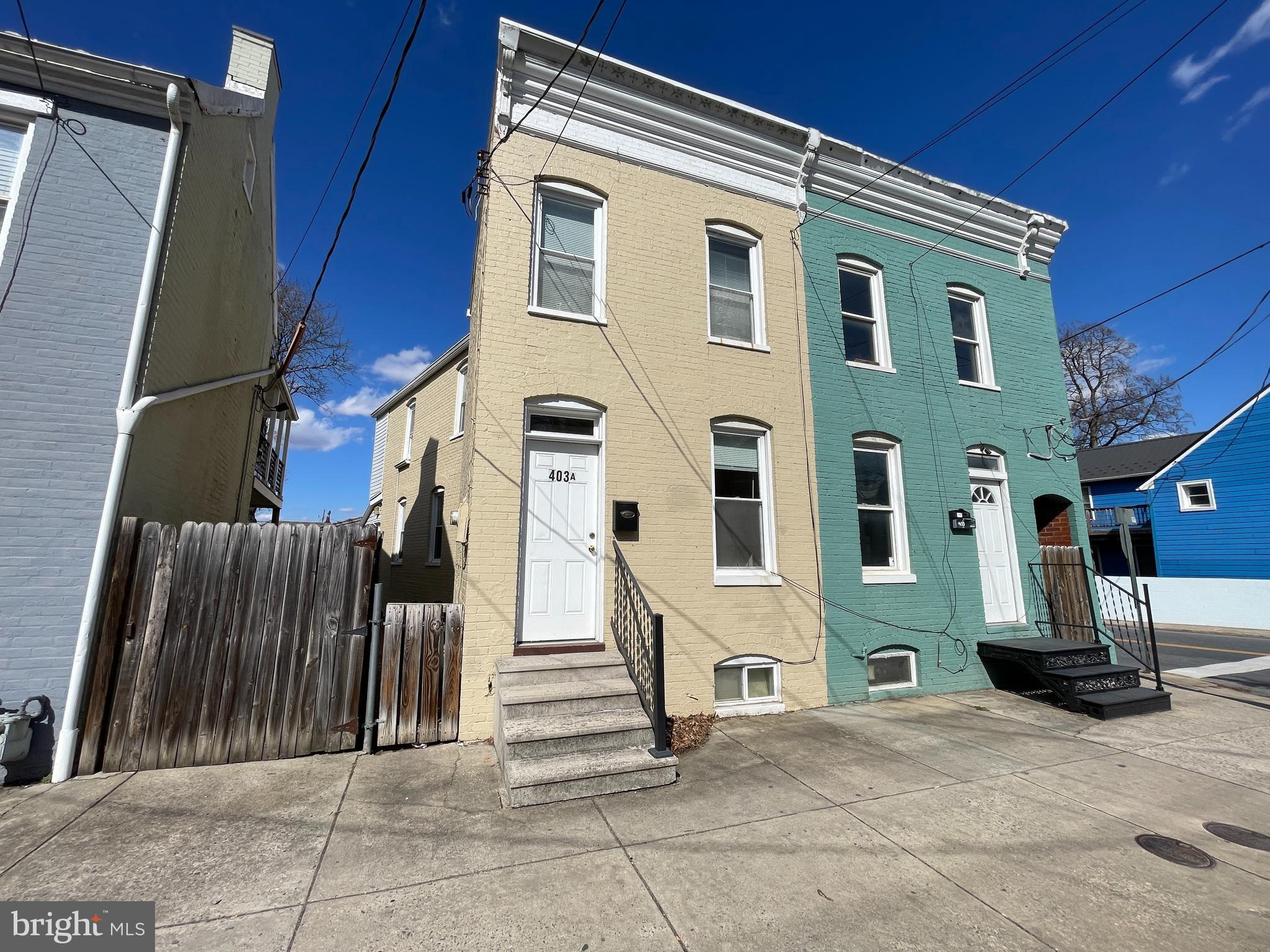 Welcome to 403A West South St! This charming and well-maintained two-bedroom row home is ready for its next occupants. Featuring beautiful hardwood floors throughout both levels, elegant wood trim accents, and exposed brick in the kitchen, this home blends classic character with modern convenience. The main level includes a laundry area just off the kitchen, while the clean, spacious basement provides ample storage. Enjoy outdoor living with a partially fenced side patio, perfect for entertaining. Plus, the property offers two rear parking spaces for added convenience. Pets are considered on a case-by-case basis— schedule your tour today!