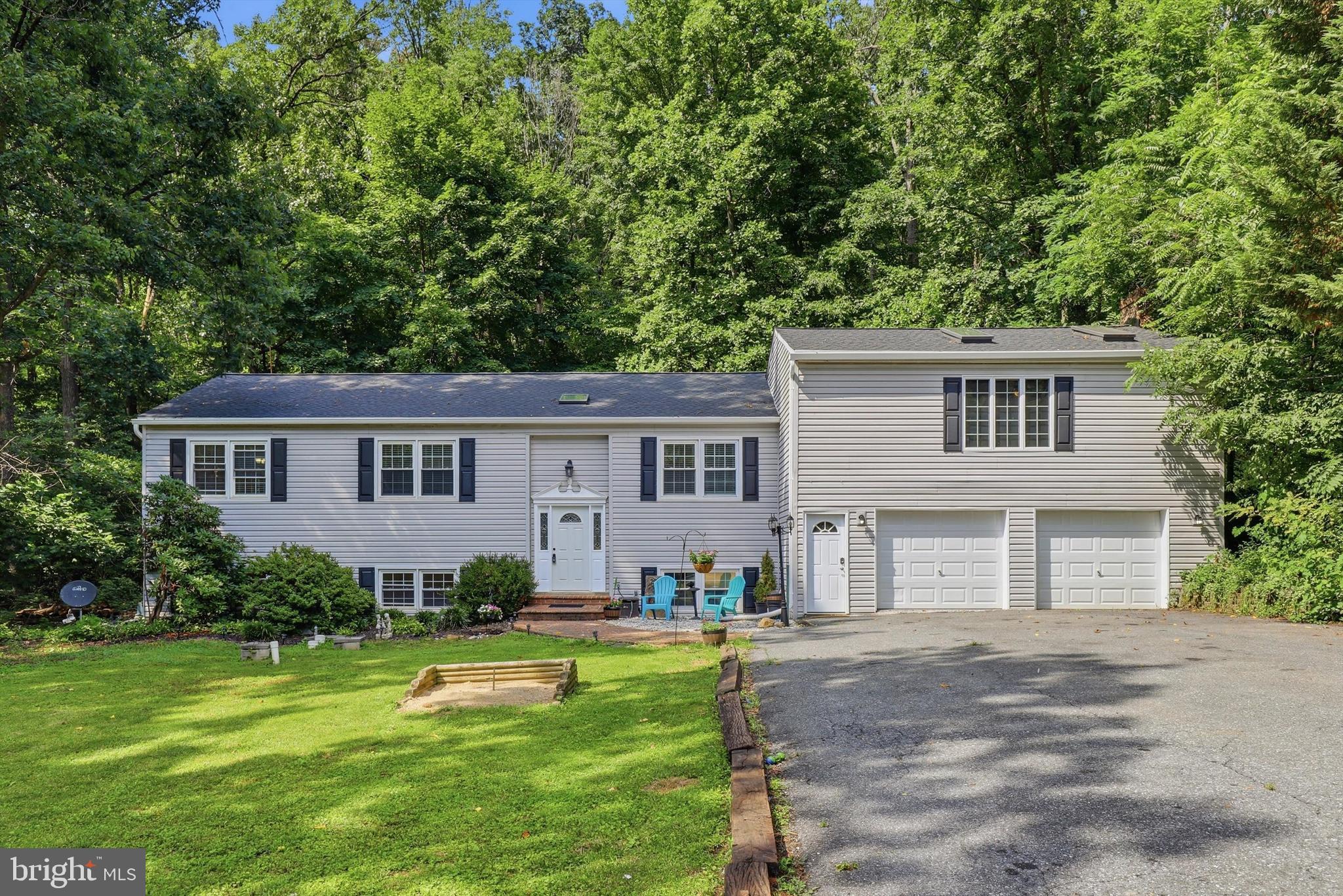 Welcome to your own private retreat! Nestled on a picturesque 1.16-acre lot, this beautifully maintained 4-bedroom, 4-bath home offers the peaceful feeling of country living while being just minutes from shopping, dining, schools, and major commuter routes. Freshly painted throughout, the home features luxury vinyl plank flooring in most rooms, with rich hardwood floors enhancing the dining room, living room, hallway to the primary suite, and the expansive primary bedroom with two skylights. The spacious primary suite is a true sanctuary, complete with a cozy fireplace that creates the perfect place to unwind with the washer and dryer conveniently located in the master bath. The bright sunroom, featuring large Andersen windows and two recently replaced skylights, fills the home with natural light and provides stunning views of the surrounding trees.
The heart of the home is the spacious kitchen, offering granite countertops, abundant cabinetry, and plenty of room for gathering with family and friends. The fully renovated basement dramatically expands your living space with a huge recreation area, an additional bedroom, and a full bath—ideal for guests, multi-generational living, or a private home office. A two-car garage provides generous parking along with ample additional storage space.
Step outside and you'll discover why this property is so special. The private rear deck is surrounded by mature trees, creating a peaceful setting for morning coffee or evening relaxation. Out front, the expansive yard is made for entertaining, featuring a fire pit, horseshoe pits, and plenty of open space for outdoor games and gatherings. Recent updates include a brand-new roof (2026), new Bulldog gutters, and a new storage shed, offering peace of mind for years to come. If you've been searching for space, privacy, modern updates, and a location that perfectly balances tranquility with convenience, this exceptional home is one you won't want to miss.