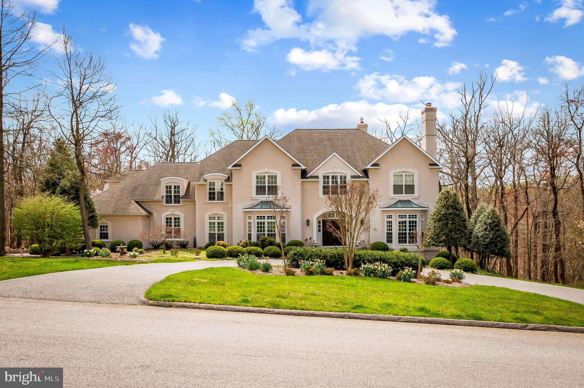 Indulge in the luxurious craftsmanship of this exquisite home, crafted by acclaimed builder Bob Pollack, renowned for using the finest materials and a meticulous attention to detail. Perfectly situated in the highly desirable community of Laurelford Court.  This home is surrounded by custom luxury properties with generous lots, open spaces, and superior features. The house radiates English Country charm with a welcoming entrance foyer and an elegant curved staircase that greets you upon arrival. The expansive open rooms are filled with natural light that pours in through oversized windows, highlighting the high ceilings, back staircase, elevator, and wonderfully finished hardwood floors. The grand country kitchen, complete with island, quartz countertops, stainless steel appliances, and ample soft-white cabinetry, leading to a sun-filled breakfast room with a curved wall of Palladian windows and soaring ceiling height.  The breakfast room leads to the family room with fireplace and French doors that open onto an expansive deck and covered porch, creating the perfect indoor-outdoor living space. The upper level boasts three large bedroom suites with generous walk-in closets. The fourth bedroom is the primary suite, complete with a private study, a dressing room with two walk-in closets, and a spa-like bath with separate vanities, making it the perfect retreat. The finished light-filled lower level features two spacious rooms, a wet bar, full bath, an exercise/wine/study area, walk-out to patio,  making it the ideal space for entertaining guests.  Located in the Falls Road Corridor, this home offers convenient access to excellent public and private schools, sophisticated shopping, restaurants, fitness centers, salons. The best of county living.  Just minutes from I83, & 695 Beltway.