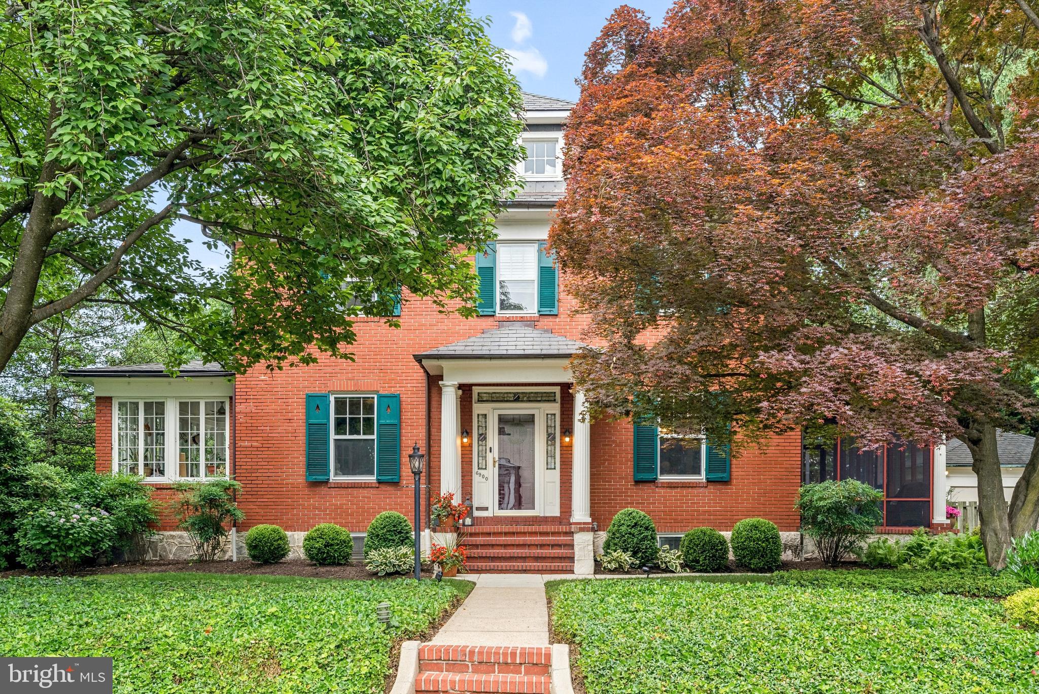 Welcome to 6900 Petworth Road, a stately, beautifully maintained brick colonial on one of the ten largest lots in Stoneleigh, offering a distinctive blend of historic character, modern luxury, and generous scale. All four levels of this move-in-ready home feature high-end systems, extensive renovations, and thoughtful finishes. Inside, center-hall proportions, high ceilings, and original 1926 touches — crystal chandeliers, a stained-glass landing, heart pine, and inlaid hardwood floors — meet a century of careful stewardship.

The main level showcases a tastefully updated kitchen with a professional Thor gas range, Monogram dishwasher, Calacatta Belrose quartz counters, refinished cabinetry, and original glass-front butler's pantry, plus a stylishly refreshed powder room and reimagined mudroom with covered radiator bench. The gracious living area features a millwork fireplace surround with Mendota gas insert, built-in bookcases, and an adjoining window-wrapped sunroom/playroom through two sets of French doors. Across the hall, fluted columns open to a true dining room, while a large three-season screened porch with built-in infrared Infratech heaters extends main-level outdoor living past summer.

Upper levels offer five bedrooms, including a second-floor primary with fitted walk-in closet and a fully renovated third-floor suite with a serene spa bath featuring a zero-threshold shower, a skylit soaking tub, and designer finishes. Additional baths are equally refined, led by a marble hall bath with double vanity. 

The finished lower level offers a wet bar with wine refrigerator, family/media room, full bath, laundry suite, and built-in bookshelf and reading nook. Outdoors, an expansive two-level deck with retractable pergola, mature specimen trees, perennial gardens that bloom spring through fall, hardscaping, fenced yard, and outdoor lighting create a year-round retreat, while the original matching brick two-car garage completes the home.

Major system upgrades include dual-zone high-velocity central air, a Navien tankless water heater, integrated audio wiring and GoldenEar and Paradigm in-ceiling speakers, weatherization and insulation, a 2013 natural gas boiler, and a 30-year roof (2010).

Set on an exceptional, level corner lot, the home enjoys a genuine sense of space in one of the area's most coveted neighborhoods, known for its tree-lined streets, close-knit community, and year-round social events. The cherished neighborhood pool and schools, elementary through high, are all within a short walk, along with coffee, dining, a gym, and everyday shops. With just six owners in a century — original blueprints convey to the seventh —homes like this rarely come to market. Meticulously improved and truly turnkey, with exceptional attention to detail inside and out — this is Stoneleigh living at its finest, ready for your next chapter.