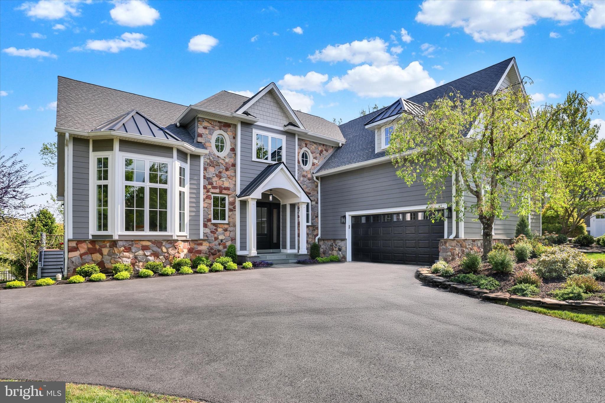 Introducing a meticulously renovated home in the heart of New Hope, showcasing a stunning blend of new Hardie-plank siding and stone accents, complemented by all-new energy efficient windows, a new asphalt roof including standing-seam metal roofing in select areas, new gutters and freshly painted throughout—offering refined curb appeal and modern comfort at every turn. Located in the sought-after community of the Estates of Riverwoods and the highly acclaimed New Hope/Solebury School District, this rarely offered “Gigliotti Built” Monet Classique offers 1st floor living at its finest! A dramatically designed portico covers the porch and provides an impressive entry to this most enticing luxury home and entry foyer. Exquisitely refinished random plank hardwood flooring extends throughout most of the main level, adding warmth and timeless elegance. Flanking the left is a formal living room, highlighted by a newly installed expansive bay window, crown, chair, and dentil moldings. The gourmet kitchen is complemented by newly installed quartz counter-tops with custom tile backsplash, additional cabinetry. Also included are stainless steel appliances including a GE 4-burner gas stove/oven with a center griddle burner, an LG Inverter Direct dishwasher, a Whirlpool microwave, a Samsung 4-door French door refrigerator, an island with new quartz counter-tops, a double door pantry and a spacious breakfast room with a large slider which exits to a spacious maintenance-free deck. The 2-story sunlit family room is enhanced by a gas fireplace with custom millwork, 2 sets of double windows, recessed lighting and a large custom chandelier. The adjacent office provides private workspace with scenic, tree-lined views that enhance the sense of seclusion. Double doors reveal the first-floor primary suite, appointed with a coffered ceiling accented by custom millwork and a sun-filled bay window. Also featured are two large walk-in closets with California Closet organizers. The owner’s bathroom is outfitted with a new double vanity with new quartz countertops and fixtures, walk-in shower, soaking tub and linen spacious closet.  A large main floor laundry room with access to the garage and a renovated half bath complete the main level of this most luxurious home. The extra wide refinished staircase leads to the upper level to a large loft.  Overlooking the main level, this airy loft presents endless possibilities—from a sophisticated home office to a serene reading retreat or secondary family room. Three spacious bedrooms, a renovated full bathroom accented with new random plan ceramic tile flooring, a new quartz countertop, tub/shower, toilet and all new fixtures enhance the bathroom. Stairs from the main level lead to the walk-out/daylight finished basement which is adorned by a large recreational room which features a gas fireplace and provides a place to relax or entertain. Pocket doors exit into the exercise room, which offers new Pergo flooring and a spacious area to work out. Exit the recreational room to Bedroom #5 which highlights a coffered ceiling with custom moldings and a pocket door leading to an enormous walk-in closet. Bathroom #3 is appointed with a large walk-in shower with a seamless glass door, and a large linen area. Exit the bedroom or exercise areas to the enormous EP Henry Patio area and the fenced backyard which boasts a renovated in-ground saltwater pool and waterslide. The backyard has plenty of exquisite landscaping as well as scenic private and wooded views. Set in a premier location, this residence is a short stroll to historic New Hope and Lambertville, the renowned Bucks County Playhouse, upscale shopping, fine dining, and cultural attractions. Enjoy boating on the Delaware River or scenic walks along the towpath, with effortless access to New Jersey, New York, Philadelphia, Princeton, the Pocono Mountains, and the Jersey Shore—offering a truly refined lifestyle.