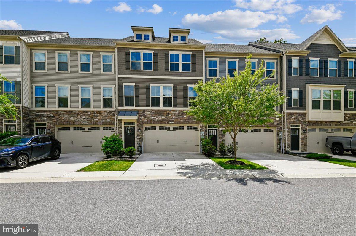 Welcome to the newest listing in The Reserve at Pondview. This gorgeous and meticulously maintained townhome has the flexible living spaces you need, and the style that will make you feel right at home. The centerpiece of the main level is the gourmet kitchen, featuring an oversized island for casual dining and meal prep, granite countertops, gas stove, and upgraded cabinetry. Just off the kitchen, a private and convenient home office is tucked away with an adjacent pantry area. Stunning floors connect the living and dining areas, enhancing the warm and open floor plan. The expansive back deck features a tree-lined view and is perfect for grilling out, entertaining and relaxing! Upstairs, the spacious primary bedroom features a walk-in closet; the bright and updated bathroom boasts dual sinks and a spacious step-in shower. You'll love the on-demand tankless hot water heater! Two additional bedrooms, both with generous closet space, plus a hall bath with tub shower, and a laundry room complete this level. The finished lower level serves as an excellent space for entertaining, a media room, gym, or a playroom. With a 3rd full bath on the lower level, this space could also very easily be converted into a spacious 4th bedroom that walks out to the rear green space.  From the two-car garage to the gas furnace, this home offers convenience and worry-free living at every turn! Community amenities also make Pondview a standout. Stroll neighborhood trails to the pond, visit the fitness center and clubhouse, or soak up summer at the pool. And there's even a fenced dog park for four-legged friends. Kids and the young at heart will love the community playgrounds! All of this comes with a convenient Millersville location close to shopping, dining, and Routes 97 and 100, with quick access to Fort Meade, NSA, and BWI Airport. Luxury, convenience, and community in one place....if you've been searching for a move-in-ready home with modern finishes and excellent amenities, this is the one. Welcome home!