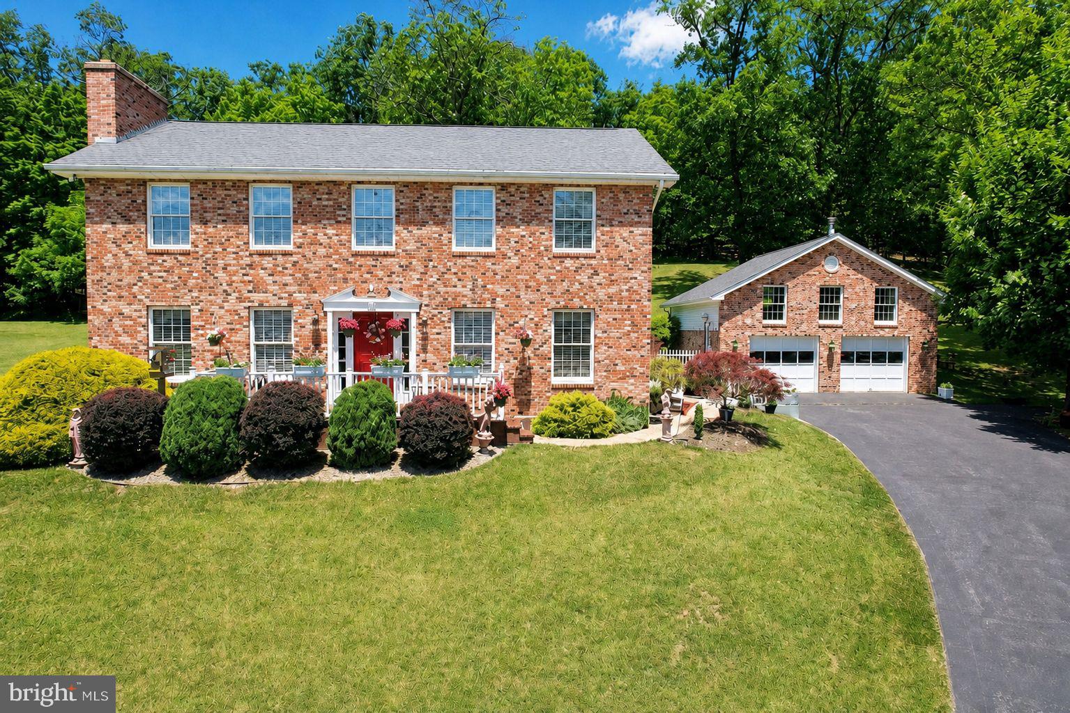 A two-story Colonial-style brick-front residence that joins timeless curb appeal with thoughtful modern living. Set against sweeping mountain views, this lovingly maintained home welcomes you with an expanded front porch—an ideal spot for evening relaxation and soaking in the panorama.

Inside, an open-plan kitchen and dining area anchors the home, featuring an ample eating counter and abundant prep space designed for effortless cooking and baking. The first floor is artfully appointed with wall sconces and stained-glass ceiling fixtures that cast a warm, sophisticated glow throughout the living spaces. A convenient first-floor laundry room adds everyday practicality.

Sunlight pours through generous windows into the living room, where a brick, gas fireplace and a room that spans the full width of the house create a luminous, airy gathering space that walks directly out to the heated in‑ground pool and surrounding concrete patio—perfect for warm summer days. The pool is surrounded by a covered porch, entertaining-ready hardscape and beautiful, professionally maintained landscaping.

On the second floor you will find a primary suite that is a private retreat with a sitting area, ensuite bath and a walk-in closet. Two additional large bedrooms each offer comfort and scale. The finished lower level expands your living options with a recreation room and wet bar, a full bathroom and a bunk room—ideal for sleepovers or guests. A heated, detached garage with an unfinished room above, provides flexible storage or hobby space, and the sale includes an additional adjoining lot, enhancing privacy.

Located minutes from the Maryland/West Virginia state line, this property combines rural serenity with easy access to shopping, dining and local amenities. Exceptional in both form and function—Call Today to Schedule Your Private Tour!!!