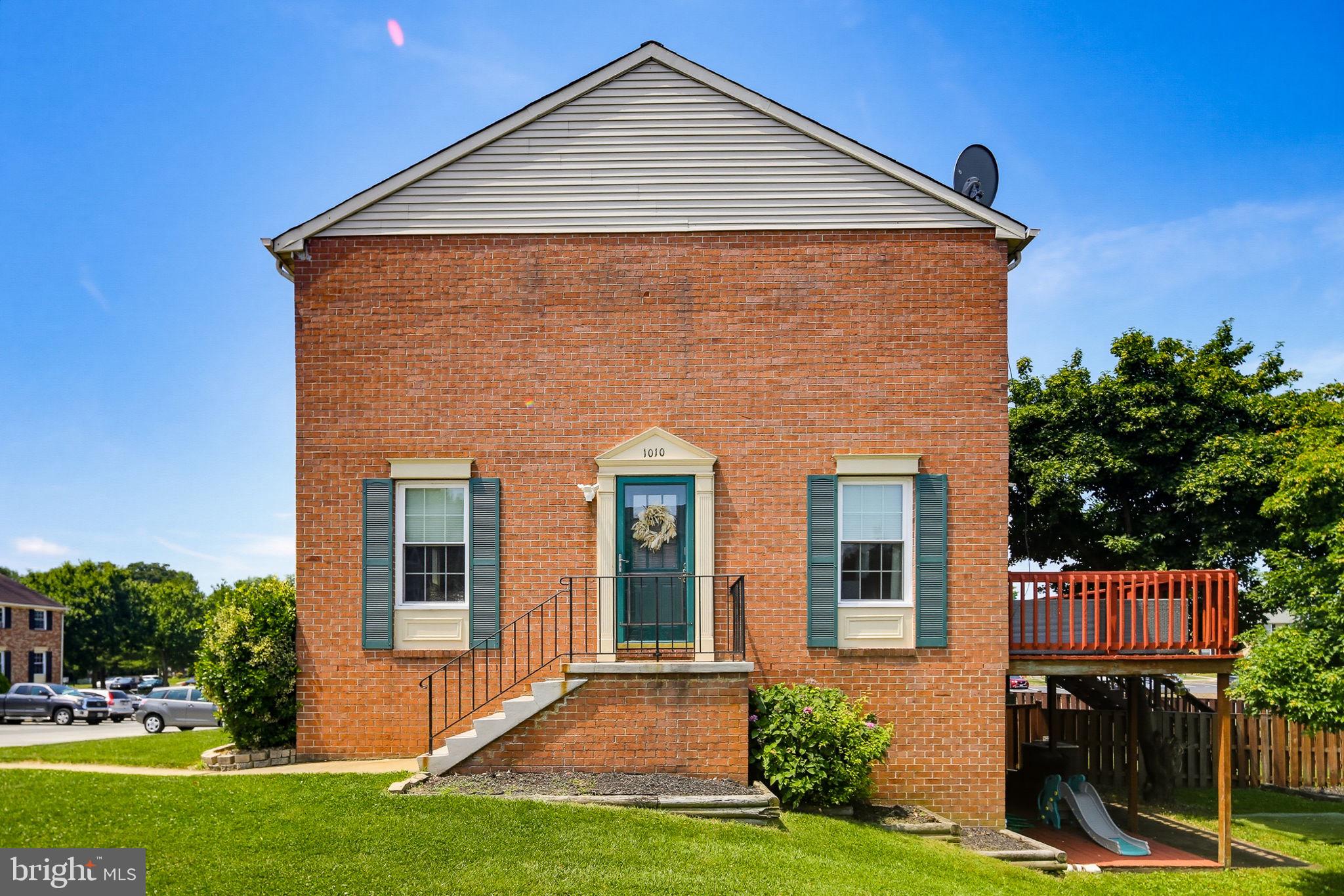 Welcome to 1010 Tennant Harbour, a charming brick-front end-unit townhome nestled in the desirable Elizabeth’s Landing community! This light-filled home offers a welcoming floor plan featuring a spacious living room with a ceiling fan that flows seamlessly into the dining area and eat-in kitchen. The kitchen is beautifully appointed with a breakfast bar and upgraded sparkling granite countertops, making it the perfect space for everyday living and entertaining.

Step outside to the private deck overlooking an expansive common area, where you can enjoy peaceful views without another home directly behind you. Whether you're grilling with friends, relaxing after a long day, or watching children and pets play, this outdoor space provides the perfect setting.

Upstairs, you'll find a beautifully renovated dual-entry full bath and a bright primary suite complete with a walk-in closet. Two additional generously sized bedrooms provide plenty of space for family, guests, or a home office.

The finished lower level expands your living space with a large recreation room featuring walk-out access to the backyard, along with a convenient half bath, laundry room, and additional storage area.

Residents of Elizabeth’s Landing enjoy wonderful community amenities, including a tot lot, private beach access, and a fishing pier, offering endless opportunities for recreation and relaxation. Combining comfort, updates, and an exceptional location, this move-in ready home is ready to welcome its next owner! Make it yours!