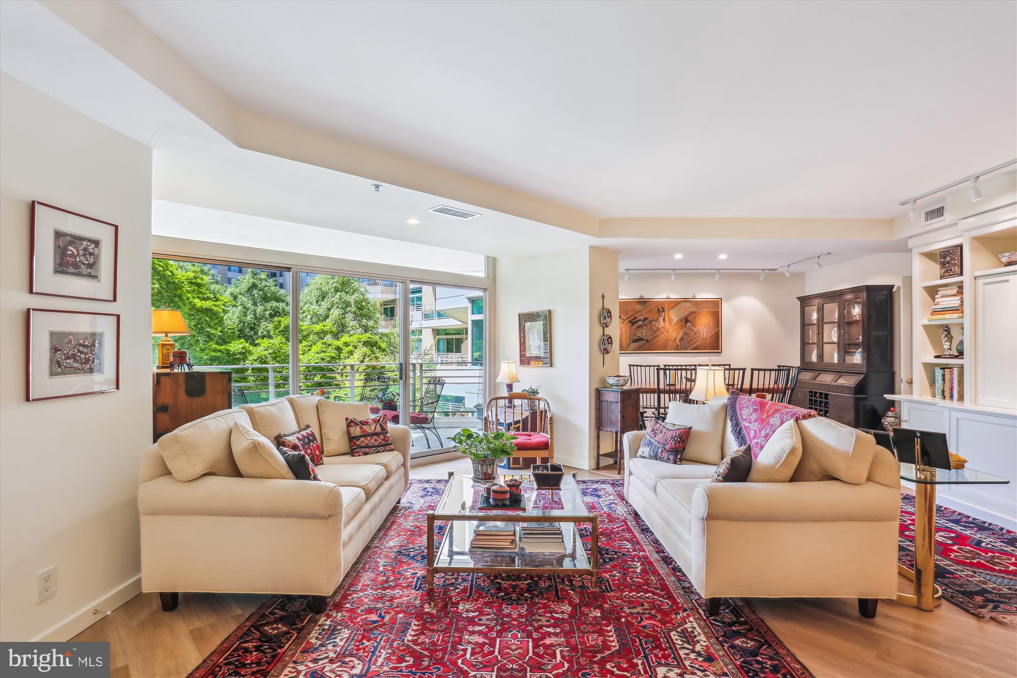 Welcome to this spectacular, light-filled 2,023 sq. ft. condo featuring a balcony with treed views! This residence has been beautifully renovated from top to bottom. It includes a welcoming foyer, an expansive living room with custom built-ins and sliders leading to the balcony, a formal dining room, and a family room/den also with custom built-ins and sliders to the balcony. This den can be converted back into the original second bedroom, which includes a full bath, as the plumbing is still in place. Additionally, there is an expanded  powder room and a private office equipped with built-in desk and cabinetry.

The gourmet kitchen boasts premium white shaker-style cabinetry, stone countertops, a ceramic tiled backsplash, and stainless steel appliances. It features a prep island, a breakfast area, and a laundry closet. 

The primary bedroom suite is a highlight, showcasing custom built-ins, a walk-in closet, and two double wall closets. The renovated spa-like bathroom offers an oversized shower, a dual sink vanity, a linen closet, and ample cabinet storage space. Throughout the condo, you will find custom shades and window treatments, beautiful wide plank flooring, and exquisite lighting and fixtures.

This sale includes two garage parking spaces (G2-200/201) and additional storage (G3-40).   Pets up to 25lbs are welcome!!

Experience elegant, resort-like living in the most luxurious complex and gated community in Friendship Heights, situated on over 17 acres. Amenities include a gatehouse, 24-hour valet service, concierge/front desk, 24-hour security, and a three-story clubhouse featuring heated indoor and outdoor pools, party rooms, a state-of-the-art fitness center, a racquetball court, billiards and ping pong rooms, an aerobics room, an art/hobby room, and tennis/pickleball courts. The grounds are lushly landscaped with walking paths for your enjoyment. 

Shops, dining, grocery stores, and the Friendship Heights Metro station are all just a leisurely stroll away.