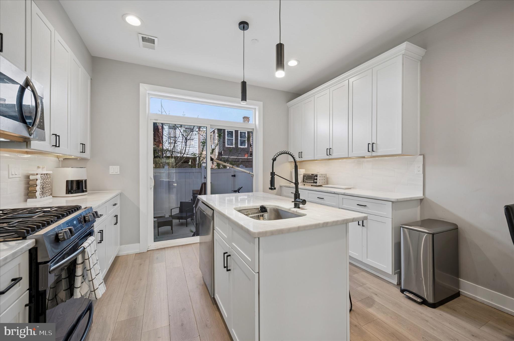 PRICED TO SELL
This move-in ready property offers a compelling combination of lifestyle appeal, smart home functionality, and long-term upside making it an attractive option for both investors and owner-occupants. Featuring a spacious, light-filled layout, the home includes luxury vinyl plank flooring, a refreshed kitchen with modern appliances, and comfortable living and dining areas designed for low-maintenance living.
Equipped with smart home technology, the property allows remote control of heating, air, locks, cameras, and security directly from a smartphone, while in-wall Bluetooth speakers add a modern, built-in feature attractive to today’s tenants and buyers alike.

The fully finished lower-level suite with a full bathroom provides valuable flexible space ideal for an additional bedroom, guest suite, home office, or potential rental setup.
A standout feature of the property is the huge private rooftop with skyline views, offering premium outdoor living and strong lifestyle appeal in today’s market.
With approximately 5 years remaining on the tax abatement, the property benefits from added financial efficiency and reduced carrying costs. Located on a quiet residential block with convenient access to Temple University, public transportation, and major roadways, the home is also just 10 minutes from Fishtown and Northern Liberties and near sought-after destinations like Suraya, Laser Wolf, and Pizzeria Beddia.