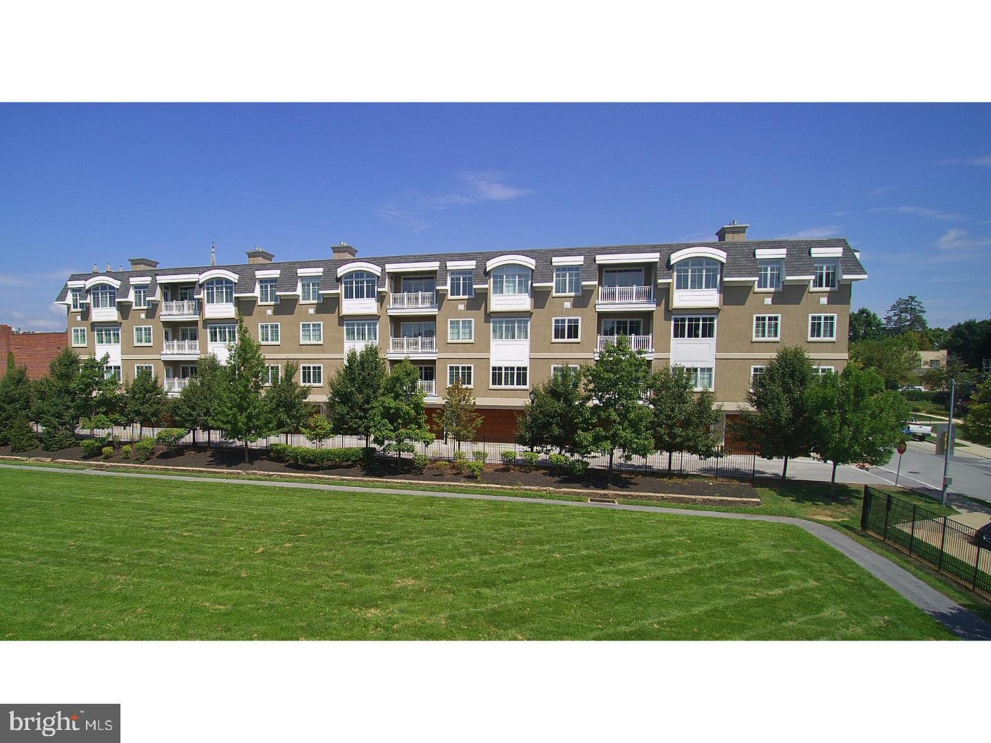 Welcome to 102 Louella Ave! One of the most sought after condominium developments in the heart of Wayne. This exquisite penthouse unit is truly the premier unit in the building.  As you enter the lobby of the building you are greeted with beautiful decorating and elevator to take you to the top floor to unit C3.  The solid wood entry door opens to a lovely foyer with wood wainscoting, a large walk-in hall closet, bedroom that could be used as study with door to balcony and full bath all with 10' ceilings  and hardwood flooring throughout the unit. Turn the corner to an expansive open floor plan including kitchen with under cabinet lighting, top of the line appliances, sub zero refrigerator, upgraded quartz countertops and large island and laundry room off the kitchen with built in cabinets and shelving. Then there is the dining room with spectacular chandelier,  bar area with cabinetry, granite counter top and under cabinet lighting and large inviting living room with built-ins and gas fireplace for family and friend entertaining.   Complementing this wonderful living space are the walls of windows with plantation shutters and a door to balcony overlooking the grassy fields below. The next stop is the 2nd bedroom with a full marble bath and walk in closet. Finally to the owner's suite which is light filled with 2 walls of windows, plantation shutters ceiling fan and views that go on forever. The expansive dressing room has custom closets organizers and windows and is anyone's dream. Luxurious owners bath with marble flooring, soaking tub, frameless glass shower, private water closet and plantation shutters makes preparing for the day a relaxing experience. Bonus features of this unit are a large locked storage unit on the first floor and a two car garage with garage door opener with inside entrance to the lobby and ideally situated near the elevator. Lastly the 2nd lobby off of Louella with a grand staircase is available if you choose the steps instead of elevator. This unit offers everything that one could want and with the convenience of walking to heart of Wayne to enjoy the restaurants, shops, train and neighbors.