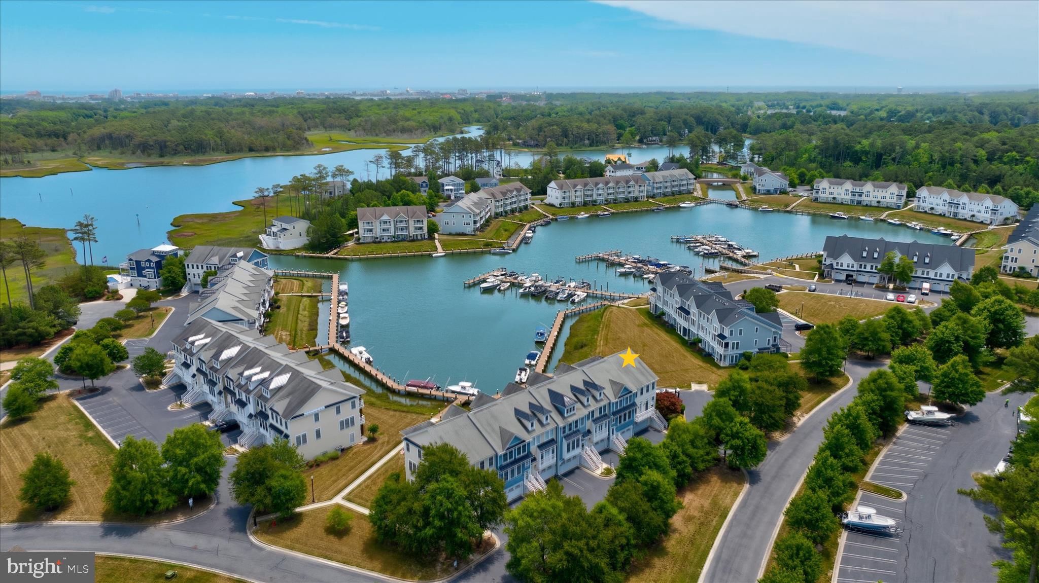 Less than three miles from the iconic Ocean City Boardwalk, waterfront living and resort-style amenities come together at 11100 Crusader Lane, Unit 107. Perfectly positioned within the prestigious gated marina and golf course community of Glen Riddle, this exceptional end-unit townhome offers panoramic marina views, beautifully updated interiors, and an extraordinary coastal lifestyle.

Spanning three levels of thoughtfully designed living space, this waterfront residence is perfectly suited for entertaining, gathering with family and friends, or simply enjoying the relaxed rhythm of life on the water. A bright and welcoming foyer introduces the home, where fresh paint throughout much of the interior, custom shiplap accents in the kitchen and dining room, updated lighting and ceiling fans, and abundant natural light create an inviting atmosphere.

The main living level showcases an open-concept design centered around a beautifully appointed gourmet kitchen featuring Cambria Montgomery quartz countertops, extensive workspace, under-cabinet lighting, decorative tile backsplash, beadboard-wrapped breakfast bar, and a new refrigerator scheduled for installation prior to July 1.  In 2025, new luxury vinyl plank flooring was installed throughout the main living areas, while new carpeting was added to the upper-level bedrooms and lower-level family room.

The spacious living room is anchored by a cozy gas fireplace with a custom surround and opens to a waterfront balcony overlooking the marina. Whether enjoying morning coffee, spectacular sunsets, or watching boats glide through the harbor, this outdoor space provides a front-row seat to the beauty of coastal living. A separate dining room, highlighted by a stylish chandelier, offers access through transom-topped doors to a private front balcony.

Upstairs, the primary suite serves as a private retreat, complete with magnificent water views and its own waterfront balcony. The spa-inspired ensuite bath features a deep soaking tub, dual vanity, large walk-in shower, and an expansive walk-in closet. Two additional generously sized bedrooms with ample closet space share a well-appointed hall bath, providing comfortable accommodations for family and guests.

The lower level offers exceptional flexibility as a family room, recreation space, or guest suite. Two sets of transom atrium doors lead to a private covered patio, creating yet another inviting outdoor living space where the marina setting can be fully appreciated. A full bath enhances functionality, while a dedicated laundry room includes a washer and dryer purchased in 2017 that have seen minimal use. Access to the finished garage provides abundant storage with shelving, storage hangers, a dedicated storage room, and an additional refrigerator. Reflecting the home's meticulous care and maintenance, both HVAC systems were replaced in 2025, providing added comfort and peace of mind for years to come.

Residents of Glen Riddle enjoy an impressive collection of resort-style amenities, including a clubhouse, fitness center, outdoor pool with splash pad, tennis courts, marina, boat ramp, kayak launch, and two championship golf courses. Fine dining is nearby at Ruth's Chris Steak House, while shopping, restaurants, medical facilities, and schools are just minutes away. World-class fishing, boating, beaches, and all that Ocean City has to offer complete this remarkable coastal lifestyle.

For boating enthusiasts, Boat Slip #54 is available for separate purchase. The slip accommodates up to a 32-foot boat and includes a convenient dock box, making it easy to embrace life on the water!  Don’t wait, schedule your private viewing today!