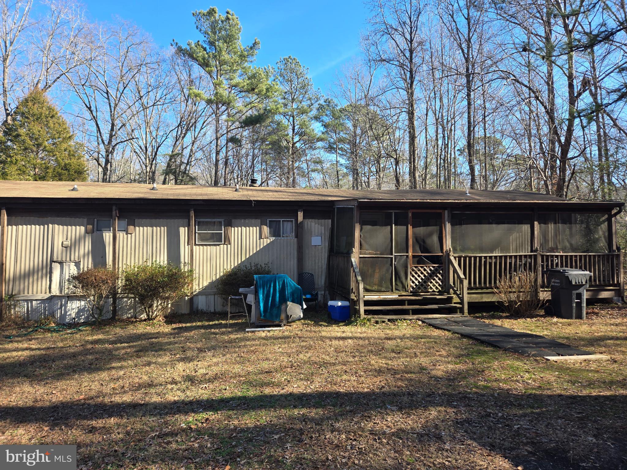 The value is in the land. 1.36 Acres in a rural setting with onsite utilities (private well & septic, electric).  The property boasts a level lot with mature trees.   Live in the mobile home while you begin the process of building your dream home.  Or continue to use the mobile home, currently under a month to month lease, as income potential. *Note: Government backed loans may not support purchase of the mobile home as a residence.
