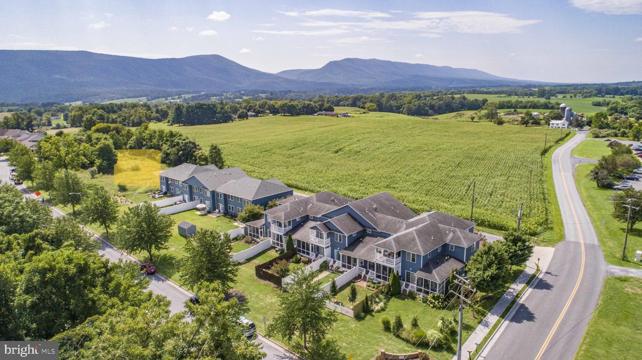 BRAND NEW TOWNHOUSES WITH MOUNTAIN VIEWS –MODERN LIVING IN WOODSTOCK LIMITED-TIME OFFER!  CONTRACTS FULLY EXECUTED BY JULY 15, SELLER WILL CONTRIBUTE $1500 TOWARD BUYER CLOSING COSTS.  DON’T MISS THIS OPPORTUNITY TO SAVE!
Introducing 3 beautifully crafted new-construction townhomes in the heart of Woodstock, Virginia.  These two-story homes offer a unique and thoughtfully designed floor plan featuring  3 spacious bedrooms, 2.5 bathrooms, and an attached garage –offering a modern lifestyle in a scenic setting.  Step inside and immediately feel the difference.  These homes are not your typical townhome layout –wide hallways, open-concept living areas, and generous room dimensions create an exceptional sense of space.  The beautiful kitchen is a true centerpiece, featuring a large stone island with seating for four, quartz countertops, solid wood cabinetry, stainless steel appliances, and a walk-in pantry just steps away.  The open-concept design seamlessly connects the kitchen, dining and living areas –creating a natural flow ideal for both everyday living and effortless entertaining.  Whether you’re hosting friends or enjoying a quiet night in, the space feels welcoming and connected.  Upstairs, the expansive primary suite serves as a peaceful retreat, with enough space for a cozy sitting area or home office.  Enjoy an ensuite bath with double vanity, a spa-inspired walk-in shower with ceramic tile extending to the ceiling, and a walk-in closet.  Front views are designed to enhance your enjoyment of the striking Edinburg Gap Mountain views.  Natural gas service is brought directly into every home, allowing for a gas stove and gas hot water heater –delivering efficiency, convenience and modern comfort.  Surrounded by the natural beauty of the Shenandoah Valley, you’ll enjoy easy access to the new Seven Bends State Park, local wineries, scenic hiking trails, and Shenandoah River recreations.  You’re just minutes from downtown Woodstock with its charming shops, restaurants, and small-town hospitality.  Don’t miss this opportunity to live in a vibrant and growing community, where comfort, design, and location come together effortlessly.   Please note: photographs are from a previously built townhome and are representative of style and layout.  Some images may show upgraded features not included in base pricing.