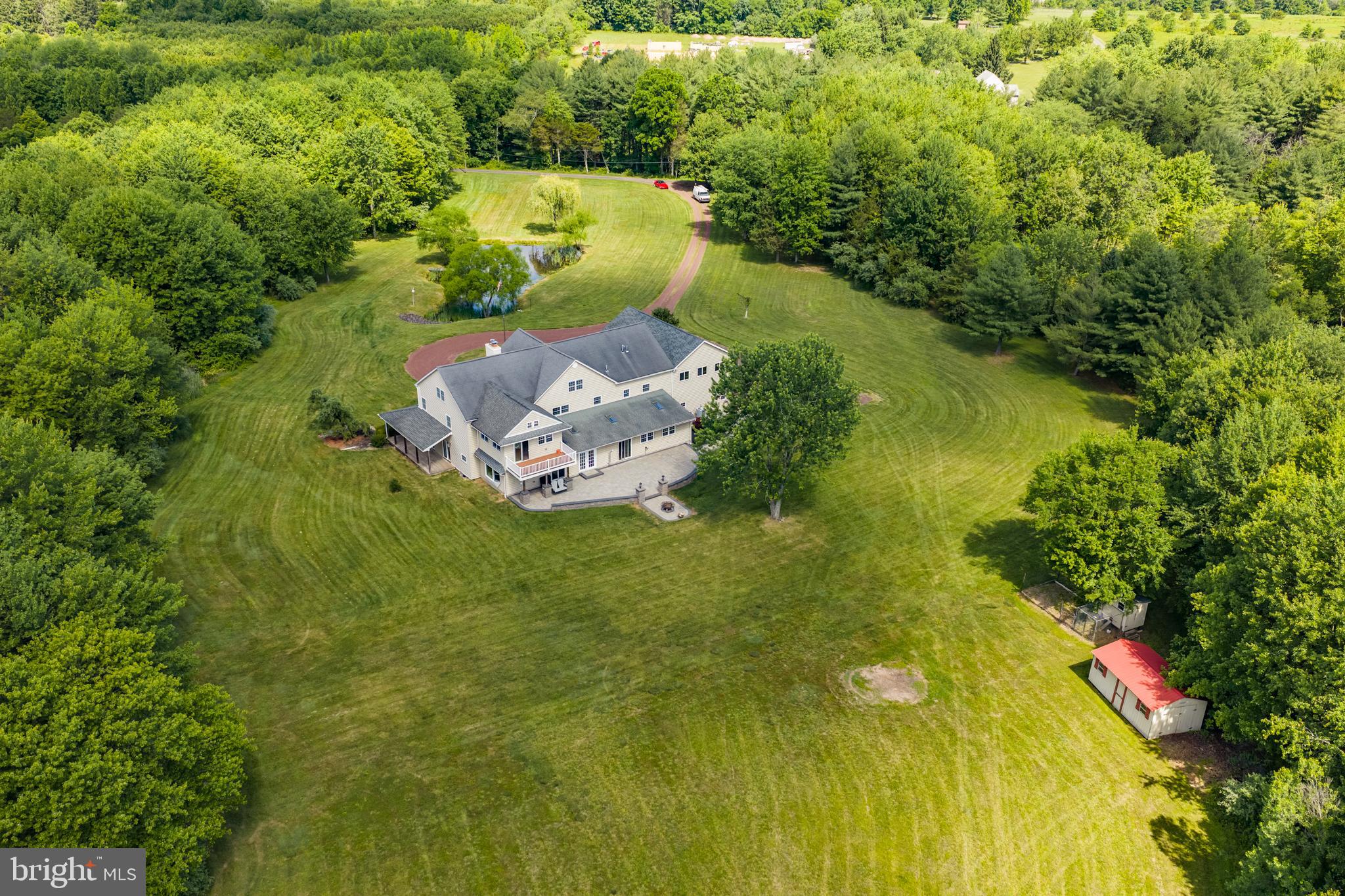 Beautiful, Move-In Condition Country Home Situated On Over 13 Acres in Sought-After Bedminster Township; This Rare Property Offers Privacy, Space, and Convenience, Just Minutes From Shopping, Groceries, Restaurants, and Everyday Needs; The Home Offers Approximately 4,784 Square Feet of Finished Living Space, Plus Unfinished Areas Ready For Future Customization; Newer Custom Attached 3.5-Car Garage Includes Interior Access, Driveway Access, and Steps to a Second-Floor Area That Could Become An Apartment, In-Law Suite, Studio, Home Office, Or Additional Living Space; The Entire Third-Floor Was Finished as a Separate Living Area When Sellers Bought The Home and is Ready to Be Refreshed Or Customized; This Property is Ideal For Those Looking For Room to Breathe, Garden, Entertain, Or Enjoy Animals; Bring Your Horses, Chickens, Or Livestock and Create The Lifestyle You Have Been Dreaming About; The Exterior Offers Outstanding Curb Appeal, While The Grounds Provide Peace, Privacy, and Possibilities; The Rear of The Home Features a Large Hardscape Patio With Lighting, a Fire Pit, and a Hook For a Hanging Swing, Creating Outdoor Space For Relaxing, Gathering, and Entertaining While Overlooking Your Private Acreage; A Shed Provides Additional Storage; Step Inside Through The Grand Two-Story Foyer Featuring An Elegant Coffered Ceiling, Stunning Curved Staircase, and Wainscoting; The Main Level Offers Newer Hardwood Flooring Throughout Much of The Home, Including The Living Room, Dining Room, and Sitting Area of Kitchen; The Living Room Features Recessed Lighting and Pocket Door Entry; The Dining Room Includes Built-Ins, Chandelier Lighting, and Space For Holiday Gatherings; The Family Room is Tucked Off The Kitchen and Offers a Comfortable Place to Relax Or Entertain, with Two Sliding Door Exits; The Gourmet Kitchen Features Natural Slate Flooring, Recessed Lighting, a Built-In Breakfast Bar, Dining Area, Attached TV, Stone Wood Burning Fireplace, Built-In Bookcase, and Built-In Bar Area; French Doors Lead to The Florida Room/All-Seasons Room, Running Approximately 63 Feet Across The Rear of The Home; Designed For Year-Round Enjoyment, This Space Includes Stamped Concrete Floors, Skylights, a Pellet Stove, Hot Tub, Pool Table, Ping Pong Table, Property Views, and Direct Access to The Patio; a Large Powder Room On The Main Level May Offer Potential to Be Converted Into a Full Bath; The Laundry Room Includes Tile Flooring and Hidden Washer and Dryer Behind Sliding Doors; Upstairs, The Spacious Primary Suite Addition Features Cathedral Ceilings, Recessed Lighting, Ceiling Fan, His-And-Hers Closets, and a Separate Sitting Room Ideal For a Home Office, Nursery, Reading Room, Or Private Retreat; a Deck Off The Sitting Room Overlooks The Rear Yard; The Custom Primary Bath Includes a Large Double Vanity and Oversized Walk-In Shower With Multiple Shower Heads; Four Additional Bedrooms Provide Space For Family, Guests, Or Home Offices; The Hall Bath Features a Stall Shower, Tub, and Stone-Look Porcelain Tile; The Third Floor Includes Existing Windows, Water, Electric, Air Conditioning, and Framing, Giving Buyers The Opportunity to Create Additional Living Space, Private Quarters, Or a Large Playroom; The Lower Level Offers High Ceilings, Painted Concrete Floors, a Workbench Area, Full Insulation, Soft Water System, Sump Pumps, French Drain System, and Direct Access to The Garage; This is An Excellent Space For Storage Or Workshop Needs; Additional Features Include Two HVAC Systems, a 400-Amp Electrical Box, a 220 Line For The Hot Tub, and a Newer Garage Roof; Entire Home Has High Density Spray Foam Including the Basement; Over 13 Acres, a Flexible Floor Plan, Exceptional Indoor and Outdoor Living Spaces, and Unlimited Possibilities Make This a One-of-a-Kind Property; Home Was Pre-Inspected, Report In MLS Downloads and List of Repairs, if Any; Priced to Sell! Schedule Your Private Tour Today;
