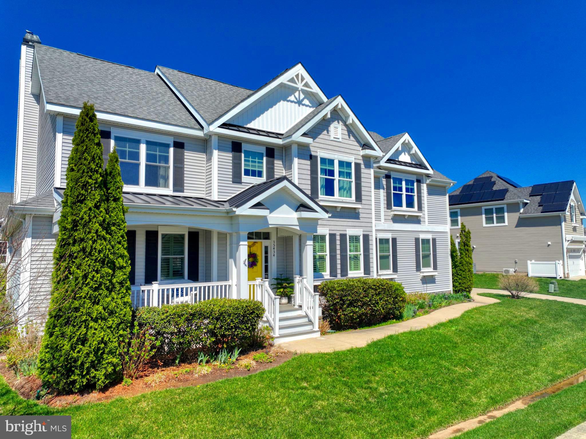 Nothing says “welcome home” quite like a charming front porch designed for relaxing. Step inside and you’re immediately greeted by a warm, inviting atmosphere. To your left, a spacious dining room with elegant wainscoting sets the stage for memorable gatherings, while to your right, a stylish powder room features beautifully inlaid tile. Straight ahead, a graceful staircase leads to the second floor.
Continuing down the hall, the home opens into a stunning living room complete with a custom bar, cozy fireplace, and plantation shuttered windows that fill the space with natural light. For some indoor/outdoor living the family room leads right out to the screened porch ready for summer evening dinners, a little TV watching and room for comfortable chairs and sofa.
The gourmet kitchen is truly the heart of the home, featuring an expansive island with seating for six—perfect for casual meals or entertaining. For larger gatherings, the adjoining breakfast room offers plenty of space for a full-size table. The pantry and mudroom are equally impressive, boasting abundant storage and organization options. Off the breakfast room, the sunroom showcases elegant coffered ceilings and provides a peaceful retreat bathed in sunlight.
Upstairs, you’ll find five generously sized bedrooms, including a stunning primary suite with a tray ceiling, ceiling fan, and a wall of plantation-shuttered windows. One of the bedrooms offers flexible use as a playroom, secondary living area, or office. A well-appointed laundry room features upper and lower cabinetry, a stainless steel sink, built-in ironing board cabinet, and hanging space. Home also includes whole house vacuum system.
The finished basement adds even more living space, complete with durable LVP flooring, a kitchenette with sink and refrigerator, a dedicated TV area, insulated walls, full 4 piece bathroom and a large egress window. You’ll also find extensive storage throughout, along with a private office space featuring direct access to the walk-out basement—ideal for working from home or hosting guests.  Residents of Sawgrass enjoy resort-style amenities, including two clubhouses, fitness centers, two pools plus a kiddie pool, pickleball, tennis, basketball, bocce, sidewalks, and a game room.