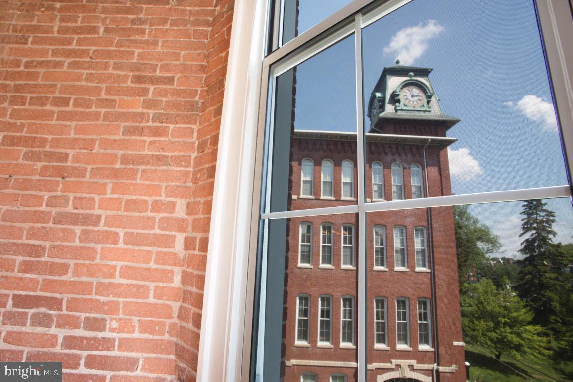 Get it while you can!  Secure building.  Beautifully updated bright 2 bedroom 2 bath condo.  Exposed brick - newly done kitchen & refinished wood floors.  Rare vault room can be used as office, wine or cigar room.  Tall windows fantastic views.  *Bonus* with acceptable offer large highly desired storage unit available right across hall.