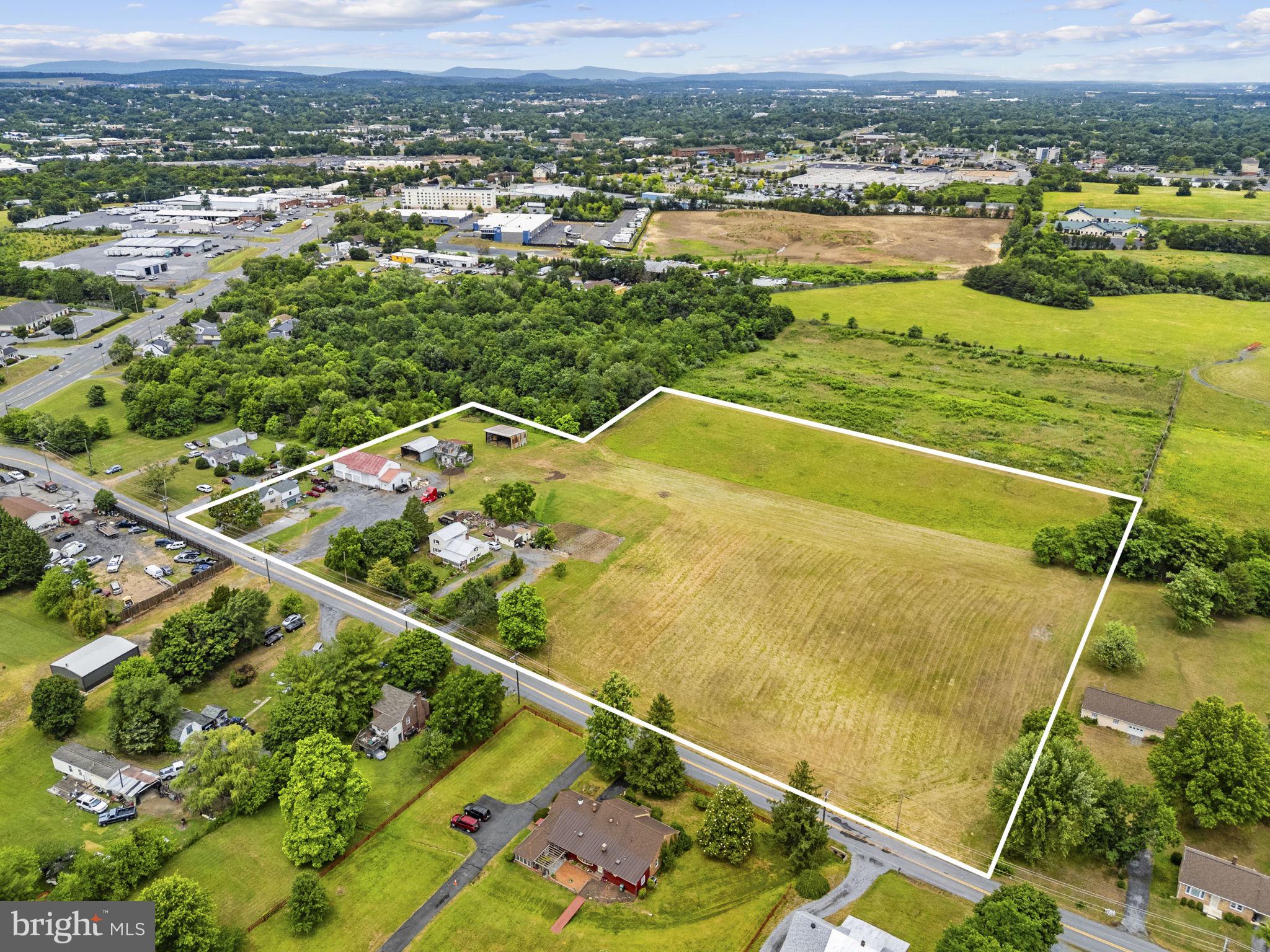 A rare commercial development opportunity awaits at 135 & 171 Bufflick Road, featuring nearly 8 acres of prime, strategic real estate in Winchester. Perfectly positioned near the airport and situated just off a highly traveled corridor, this unique property provides unbeatable visibility, high traffic exposure, and immense future potential. The dual zoning of RA and B1/B2 opens the door to a wide array of development possibilities, making it a dream canvas for investors, developers, or business owners looking to establish a footprint in a rapidly growing area. Beyond its long-term development upside, the property is a turnkey income generator from day one. It features two existing rental homes that provide immediate cash flow while you finalize your development plans. Additionally, the large, multi-bay commercial garage offers substantial extra income potential—perfect for equipment storage, automotive work, or a workshop space. Complete with a large gravel staging lot ideal for fleet parking or heavy equipment, this property is a rare find that perfectly balances immediate rental revenue with massive commercial scale.