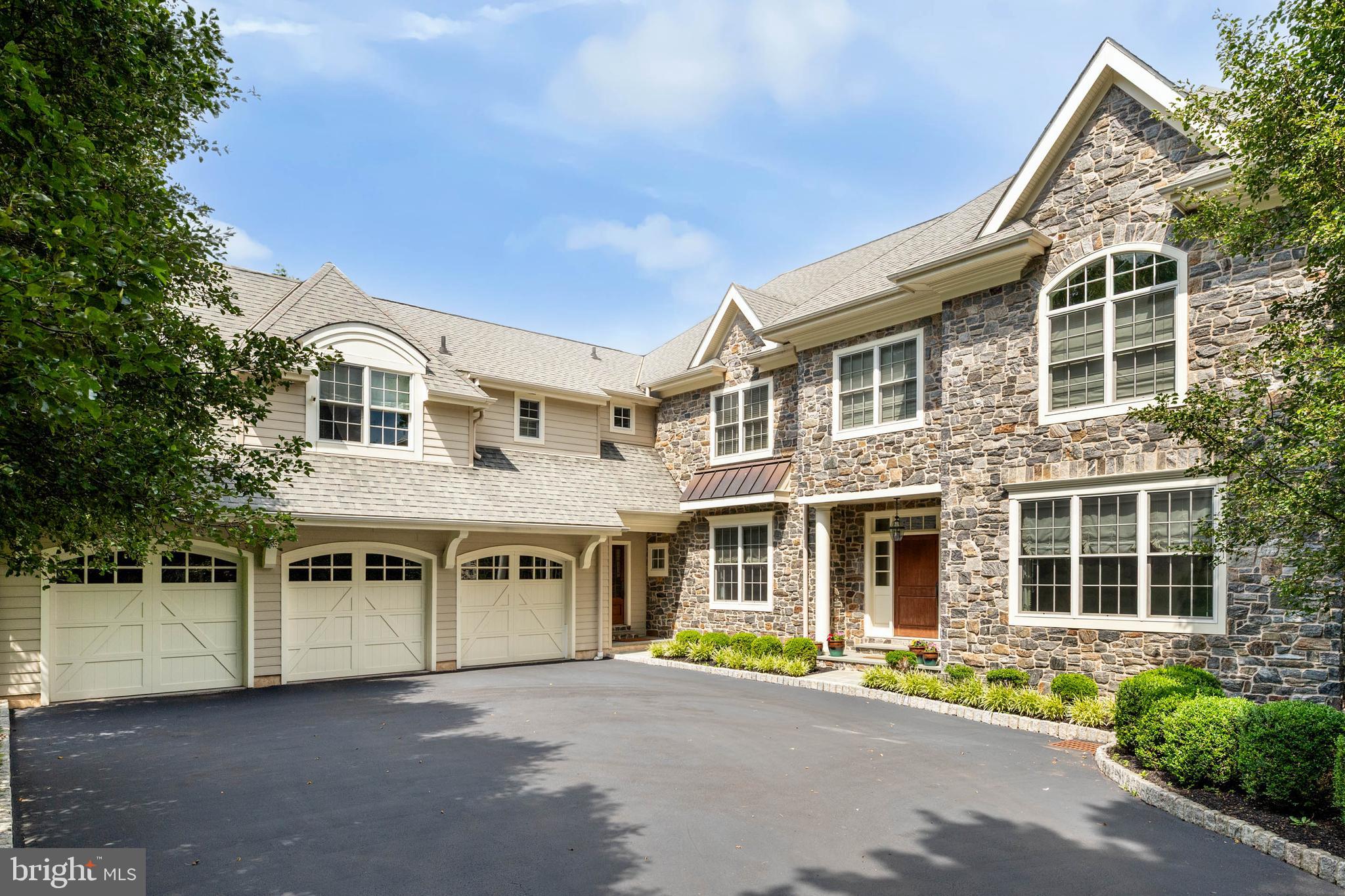 Set on over one beautifully landscaped acre in a premier Bryn Mawr, Main Line location within the highly acclaimed Lower Merion School District, this exceptional stone and Hardie Plank estate, built in 2012, offers an extraordinary blend of timeless architecture, refined craftsmanship, and modern luxury. With more than 7,700 square feet of impeccably designed living space, including approximately 5,670 square feet on the main and upper levels and over 2,000 square feet of beautifully finished walk-out lower-level living space, this light-filled residence is thoughtfully designed for both grand-scale entertaining and comfortable everyday living.

A grand, wide center hall foyer with 9-foot ceilings welcomes you into a gracious floor plan featuring a formal living room with fireplace, an elegant dining room, a private first-floor office overlooking the beautifully landscaped grounds, and a spectacular great room with soaring ceilings, a fireplace, and expansive windows that fill the home with natural light.

At the heart of the home is a stunning gourmet kitchen featuring a professional-grade Thermador gas range, extensive custom cabinetry, generous counter space, and an oversized center island with seating and designer pendant lighting. A beautifully appointed butler's pantry with a beverage refrigerator and additional cabinetry enhances both style and function, while the adjoining great room creates the perfect gathering space for everyday living and entertaining.

The luxurious primary suite is entered through double doors into a private sitting room with a fireplace and custom built-in cabinetry. The spacious bedroom features a tray ceiling, two walk-in closets, and a spa-inspired bath with a soaking tub, oversized shower, and separate vanities.

The upper level also offers generously sized secondary bedrooms, beautifully appointed bathrooms, and an oversized laundry room.

The finished walk-out lower level is designed for entertaining and recreation, featuring expansive gathering areas, space for billiards and table tennis, a dedicated screening room, a generously sized fitness room, and lower level full bathroom has steam shower.

Outdoor living is equally impressive with a private, level, fenced backyard featuring a resort-style pool and hot tub, extensive hardscaping, a spacious deck, expansive lawn, and mature landscaping, creating a secluded setting for entertaining and relaxation.

Additional highlights include five bedrooms, five full bathrooms, two powder rooms, three fireplaces, a three-car garage, tasteful designer lighting, oversized window systems, and exceptional craftsmanship throughout.

Ideally situated in a premier Bryn Mawr, Main Line location, this exceptional residence is just minutes from township parks and recreational facilities, the shops and restaurants of Villanova, Bryn Mawr, and Wayne, and the premier dining, shopping, and business destinations of King of Prussia, Conshohocken, and Center City Philadelphia. Convenient access to major highways, regional rail service, and Philadelphia International Airport provides outstanding connectivity while enjoying the tranquility of this exceptional setting.

A rare opportunity to own an extraordinary estate in one of the Main Line's most sought-after neighborhoods, combining timeless elegance, luxurious amenities, an exceptional lifestyle, and an unparalleled Bryn Mawr location.
