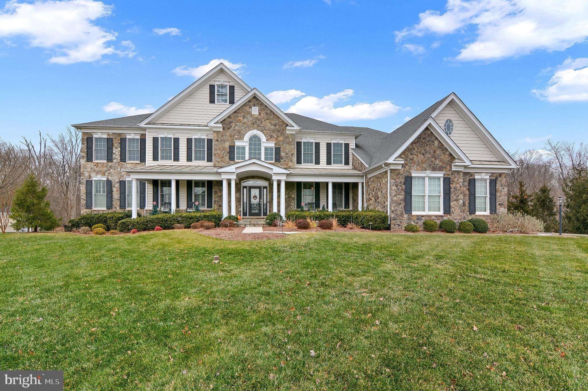 Welcome to Dominion Valley. This exquisite Toll Brothers Hampton model, built in 2014, offers nearly 9,300 square feet of refined luxury in the prestigious gated section of Dominion Valley Country Club, beautifully positioned on a premium 1-acre homesite with inground sprinkler system and landscaping lights to show off this gorgeous home at night.

Boasting 6 spacious bedrooms, each with its own en-suite bath, plus 2 additional half baths, this residence is designed for comfort, privacy, and effortless living. An expanded three-car side-load garage sets an impressive tone from the moment you arrive.

Step outside to your private resort oasis, complete with a sparkling pool, integrated hot tub, expansive patio, and a Trex deck with a rooftop level—a dream environment for year-round entertaining.

Inside, the home captivates with its dramatic dual Cinderella staircase with wrought-iron spindles, complemented by a rear staircase for added convenience. The two-story family room features a striking gas fireplace, while the gourmet chef’s kitchen showcases high-end stainless steel appliances, including a 6-burner Monogram commercial range and hood, separate wall oven and microwave, an oversized island with vegetable sink, and premium finishes throughout. A large conservatory off the living room provides an elegant extension of your entertaining space. The home also includes a dedicated laundry room with sink and brand-new high-end front-load washer and dryer on main level.

The massive primary suite is a sanctuary of its own—featuring a spacious sitting room,  tray ceiling, three-sided gas fireplace, dual walk-in closets adorned with two chandeliers and a window, and an expansive spa-inspired bath with dual vanities, two water closets, and a large shower with dual shower heads.

The fully finished walkout lower level includes a game room, theater, exercise room, bedroom, and generous flexible spaces perfect for recreation with fireplace, hosting, or multigenerational living. The home also includes a dedicated laundry room with sink and brand-new high-end front-load washer and dryer on main level.

All of this is set on a tranquil lot backing to mature trees, creating the ultimate private retreat for enjoying the covered deck, pool, and hot tub—an extraordinary offering within one of Northern Virginia’s most sought-after communities.
