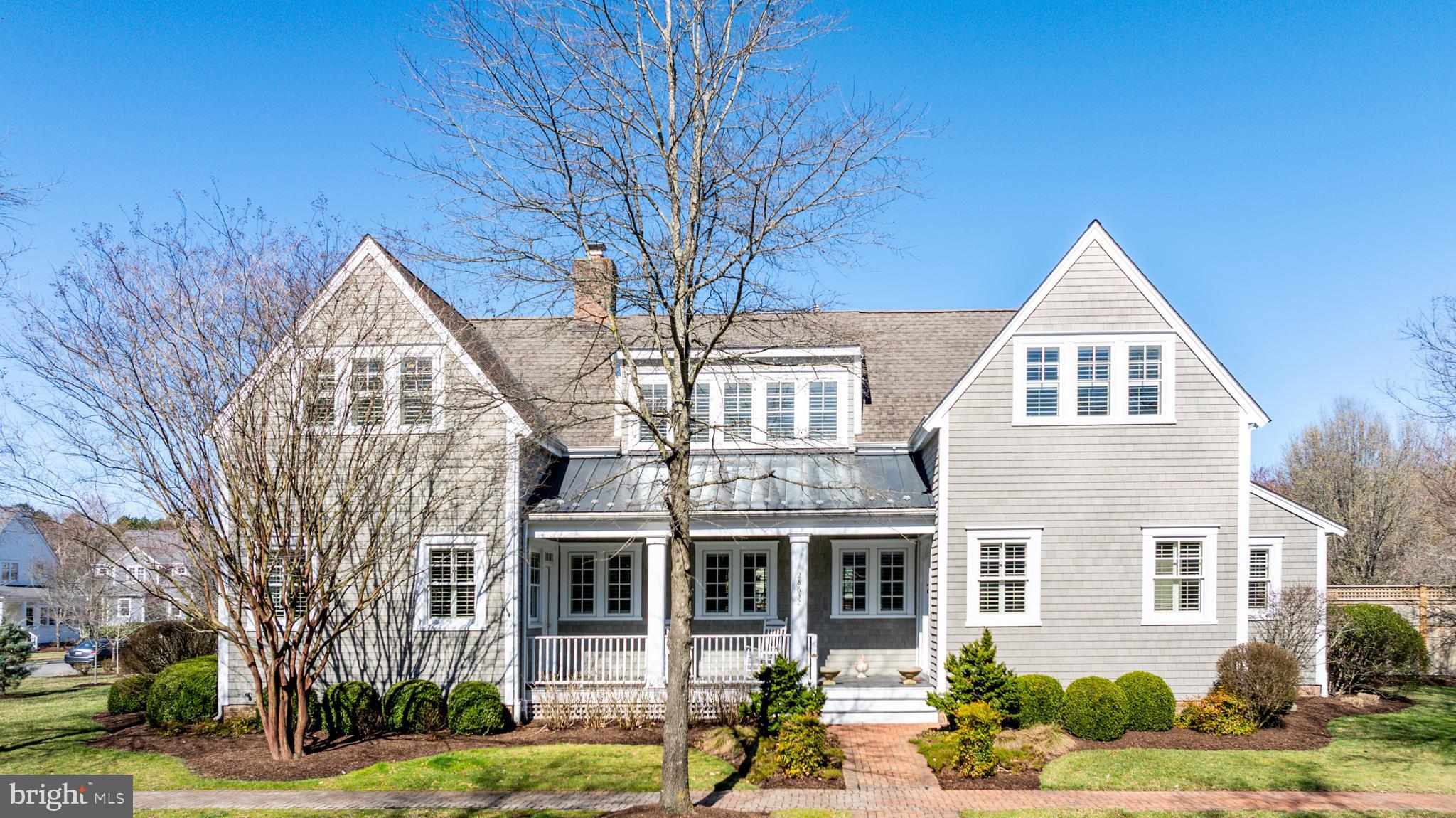 Combining timeless coastal charm with modern upgrades, this exceptional property in Cooke’s Hope offers a rare opportunity to enjoy elegant waterfront-inspired living in a picturesque setting. Designed by renowned architect Lyman Perry and built by Ilex Construction, this meticulously maintained coastal-style home in the desirable Cooke’s Hope community offers an exceptional blend of craftsmanship, elegance, and modern convenience. Situated on a large half-acre+/- corner lot with serene views, this residence boasts 5 bedrooms, 3.5 bathrooms, and a detached 2-car garage with a studio above. The thoughtfully designed floor plan features a desirable main-level primary suite, ideally curated living spaces, and a versatile fifth bedroom or private office with exterior access. A bonus room with skylights provides additional flexible living space, perfect for a studio or office. Throughout the home, custom shutters, 8-foot solid cherry pocket doors, and a floating cherry bookcase with a fireplace enhance its character and warmth. The gourmet kitchen is equipped with custom solid wood cabinetry, Monogram & KitchenAid stainless steel appliances, a French door double oven, high-velocity range hood with a remote motor, and a 56-bottle wine fridge. Custom tile baths and high-end finishes throughout the home reflect meticulous attention to detail. Outdoor spaces are equally impressive, featuring a custom pergola, lush landscaping, fully irrigated yards, and ample room for a pool. The top-of-the-line NuCedar siding ensures a maintenance-free exterior, while Benjamin Moore Aura exterior paint covers all trim. This coastal retreat is designed for both luxury and efficiency, with a sealed crawl space, Aprilaire whole-home air and humidity control systems, and extensive underground drainage.