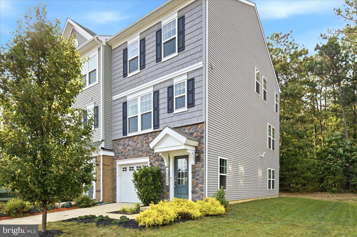 Welcome to 44042 Eucalyptus Way in the sought-after Wildewood community of California, MD — a beautifully maintained, nearly new townhome offering modern finishes, flexible living space, and a location that’s hard to beat. Built in 2021, this desirable end-unit location offers added privacy with just one adjoining neighbor, extra windows that fill the home with natural light, and additional green space to enjoy.

The main level is bright, open, and ideal for both everyday living and entertaining. At the heart of the home is a stunning custom kitchen featuring a huge center island, stainless steel appliances, built-in microwave, abundant cabinetry, and a spacious dining area. Just off the dining space, step out onto the rear deck overlooking a secluded backyard, creating the perfect setting for morning coffee, outdoor dining, or simply unwinding in a peaceful outdoor space. The kitchen flows seamlessly into the large family room, making the entire main level feel connected and inviting.  The main level and lower levels feature beautiful LVP flooring.

Upstairs, you’ll find comfortable bedroom space and well-appointed baths, while the finished lower level offers a valuable bonus room/bedroom, ideal for guests, a home office, gym, playroom, or additional living space to fit your needs. A one-car garage adds everyday convenience and extra storage.

Located in the amenity-rich Wildewood neighborhood, residents enjoy access to community amenities such as a pool, clubhouse, tennis courts, playgrounds, parks, and walking trails. The HOA also includes trash pickup, recycling and snow removal.  Commuters will especially appreciate the home’s close proximity to PAX River Naval Air Station, along with nearby shopping, dining, and everyday conveniences throughout California and Lexington Park.

If you’ve been looking for a move-in ready home with modern style, flexible space, neighborhood amenities, and an easy commute to PAX River, 44042 Eucalyptus Way is one you won’t want to miss.