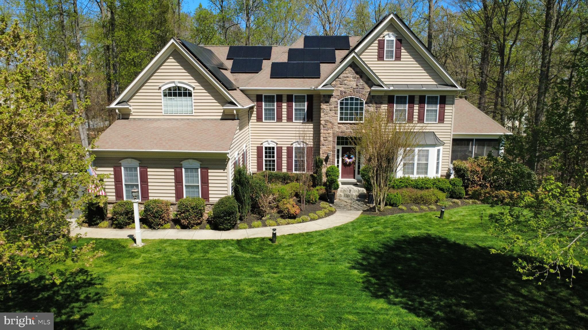 Check out this ENERGY EFFICIENT home!  Open floor plan with classic elegance with modern efficiency located on 3 acres offers a perfect blend of elegance with beautiful landscaping. Originally the builder's model for Quaker Custom Homes, this property showcases the high quality craftsmanship this builder is  known for, including real hardwood floors, lots of high-end moldings.

The main level features a grand two-story family room with a cozy gas fireplace and wall-to-wall  windows. The open floor plan flows seamlessly into a light-filled country kitchen, complete with a large granite island, all-new appliances, and a walk-in pantry. Off of the kitchen is a sunroom with access to the deck with views of trees.  The three-car side-load garage is equally impressive, featuring  Gladiator wall-to-wall organizer panels, matching cabinetry, an extra refrigerator, and even has a car charging port.

 This home has 5 bedrooms all with attached bathrooms (5), one  bedroom/office of which is on the main level and has a door leading to a screened in sunny porch.  This four season room/porch has a thick clear vinyl roll down curtain custom made for this space and also a built- in room heater ( A/C too) for those cool days in the winter.  The spacious owner's retreat has access to a  second covered  porch,  gas fireplace, coffee bar, sink, small refrigerator and two walk-in closets. A spa like bathroom has two seperate sink vanities as well tub and large shower. The finished lower level has a TV hookup with built-in speakers which convey. Built -in cabinets and a kitchenette with  bar area to include  a full size refrigerator. There is an amazing long vent free  two sided fireplace that has a switch to light up the fireplace when not in use. In addition, located on the lower level is an en-suite with a huge walk in shower perfect for your guests. The walkout basement to the patio has easy access to the above ground heated pool which includes, cover, pool robot vacuum & pool liner (2025).  Don't miss the shed for extra storage with room for a riding mower and workbench. Big savings on your electric bill with already installed roof solar panels. Roof solar panels were installed in 2020 and have a 25 year warranty. This roof also has gutter guards already installed. This yard will stay lush with an 8 zoned sprinkler system.  As a added bonus this home offers whole house speakers in most rooms for bluetooth  music, components convey; there is also a speaker/controller in the garage.  It is worth noting the property has city water and sewer, not well and septic as most would expect with a home on this much land.  The home is located near shopping and commuter lots and a quick drive to I-95.  Come view this amazing home and yard that doesn't disappoint.      The sellers are offering a 2-10 home warranty exp. Nov 2026.