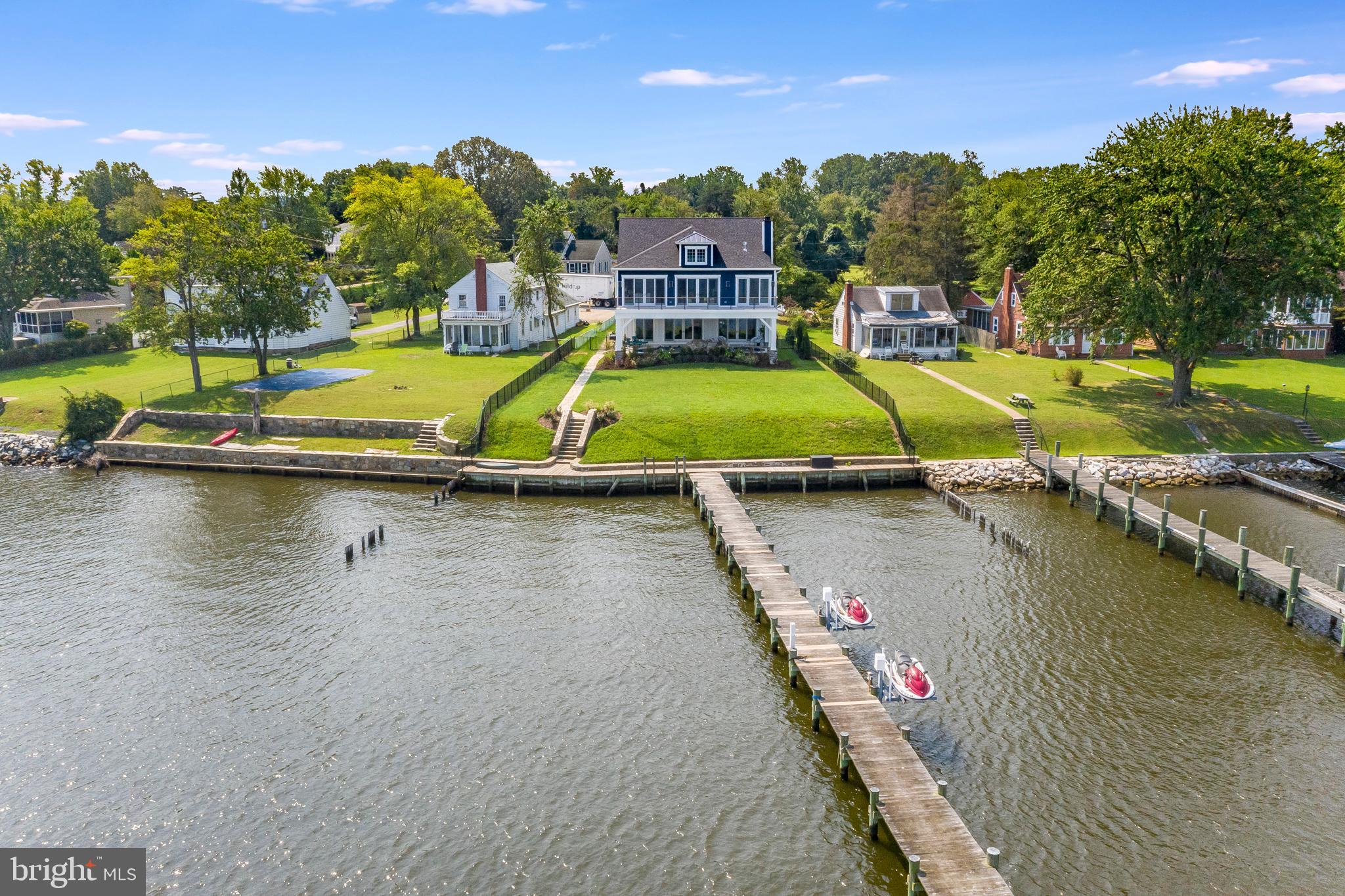 *NEW RIVERFRONT PRIVATE ESTATE* Welcome to this brilliantly designed new construction home, an original masterpiece built along the shores of the Magothy River in Arnold, Maryland. 557 Broadwater Road was thoughtfully detailed and built for the new owners to experience a true luxury living lifestyle, surrounded with sensational riverfront views. With direct Magothy River frontage, boating enthusiasts will enjoy a private 350 ft. dock with water, electric, and 7 feet of water depth. An abundance of features and amenities include public water/sewer, and natural gas.  The master chef kitchen has top of the line appliances, gorgeous quartz counters, 42 inch maple cabinetry, and an oversized island. Coffered ceilings, soaring glass windows, and 8 ft. tall doors compliment this striking floorplan. Large open family room with wood burning fireplace is perfect for all seasons. Step outside onto a stunning stone patio and enjoy your very own waterside saltwater pool with built in seating and a beautiful waterfall! Impressive private master suite has picturesque water views, walls of windows, lounging area with gas fireplace, enormous walk-in closets, and your very own yoga/workout room! Enjoy evening sunsets and morning coffee on the multiple decking overlooking the gardens and riverfront. The bedrooms, en suite, are expansive and complimented with large walk-in closets. All baths have beautiful fixtures, hand selected tiles, and sleek granite vanity tops. For added convenience, the home elevator is cleverly placed, making all areas of the home accessible for everyone. This stunning estate was built by one of the finest custom home builders in Anne Arundel County, Cedar Square Homes. Celebrate your Holidays and start new traditions with friends and family in this new waterfront estate, which awaits to be filled with your treasures. Welcome home.