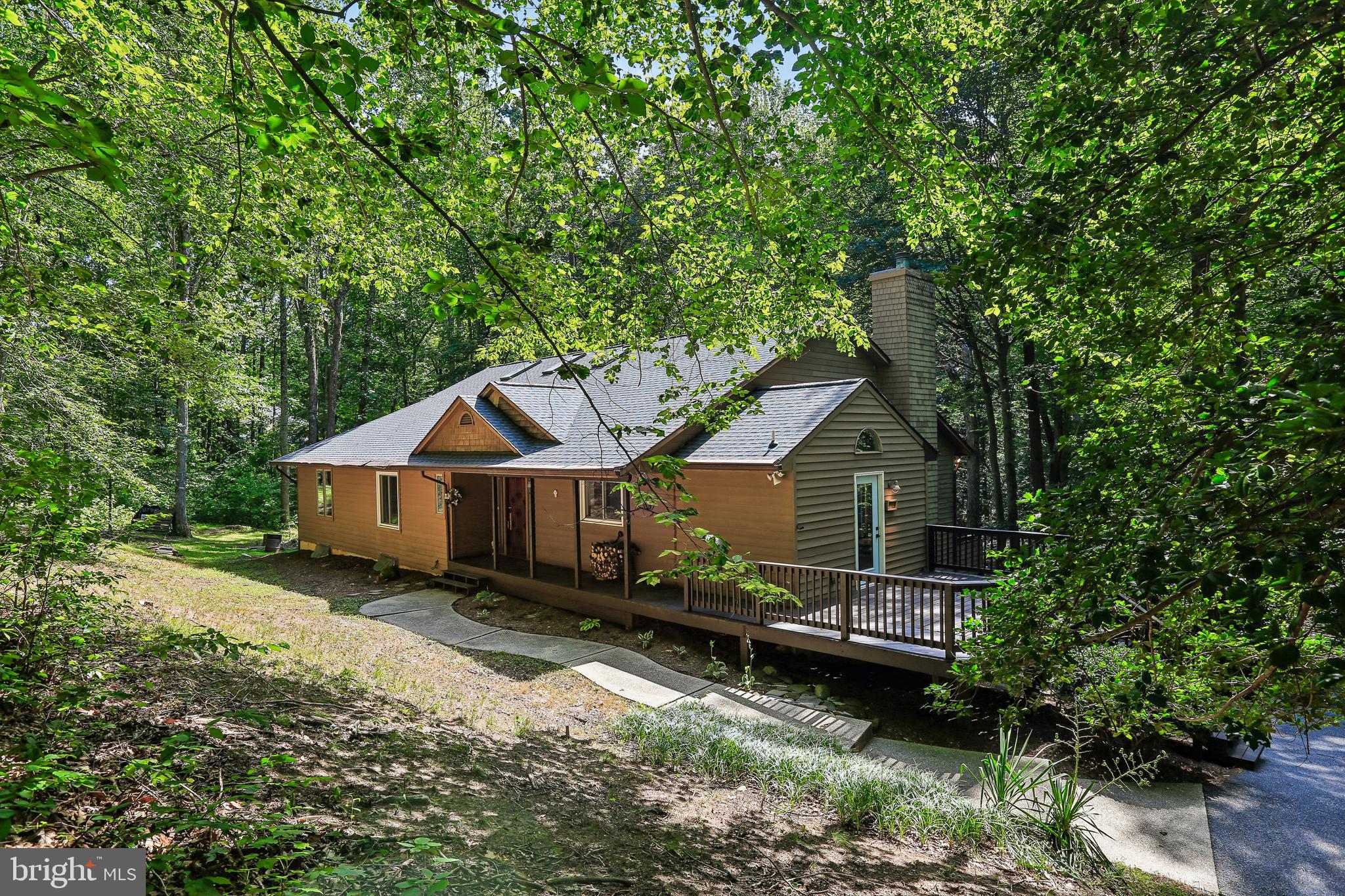 Set on approximately 9.85 acres with private forest views, this 4-bedroom, 3.5-bath split-level home offers space, flexibility, and numerous recent updates. The thoughtfully designed layout features multiple living areas to accommodate a variety of needs. The lower level includes an in-law suite with space for a potential kitchenette, while the lowest level offers an additional finished room that could serve as a potential fifth bedroom, home office, gym, or hobby space.

Recent improvements include freshly painted interior and exterior, an updated deck, renovated primary bathroom, updated HVAC system, chimney improvements, and numerous electrical and plumbing updates. Surrounded by mature trees and scenic views, this property provides a peaceful setting with room to enjoy both indoor and outdoor living.